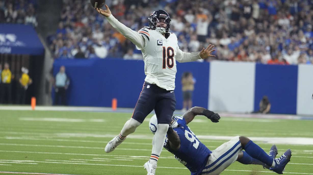 Chicago Bears quarterback Caleb Williams (18) is pressured by Indianapolis Colts defensive end Tyquan Lewis (94) during the second half of an NFL football game Sunday, Sept. 22, 2024, in Indianapolis.