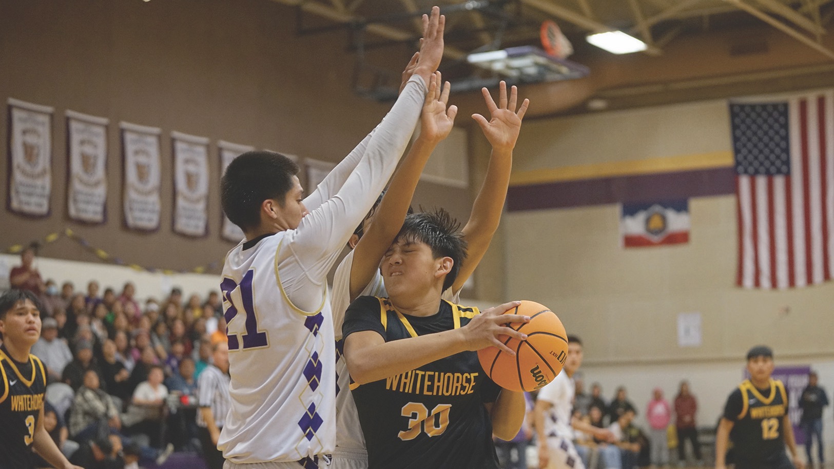 Whitehorse High School's Adam Joe faces the defense of Monument Valley High School's Melias Cly in a game on Jan. 26. High school basketball as played on reservations is the focus of a new Netflix film.               