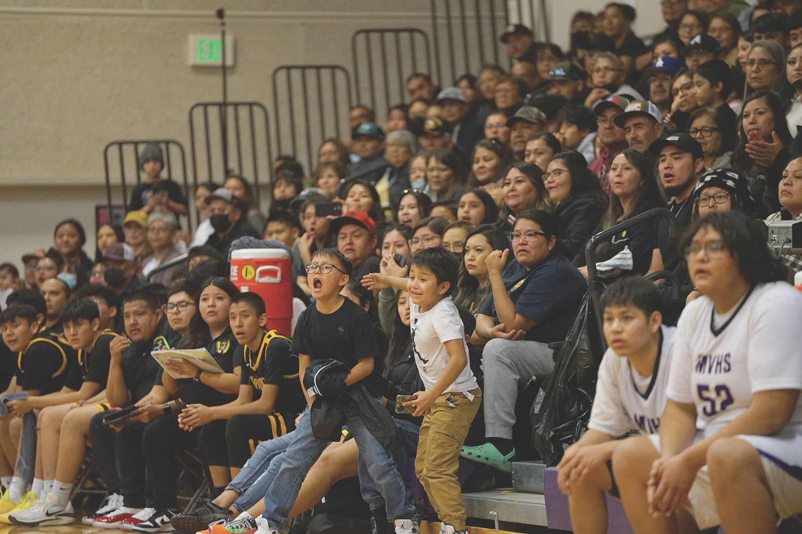 Two youngsters cheer for the Whitehorse High School boys basketball team during its rivalry game with the Monument Valley High School squad on Jan. 26, 2024.