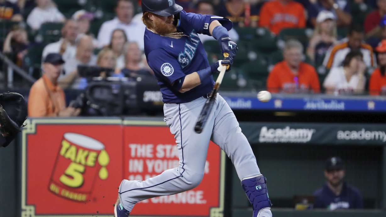 Seattle Mariners' Justin Turner hits a two-run RBI single against the Houston Astros during the sixth inning of a baseball game Wednesday, Sept. 25, 2024, in Houston.