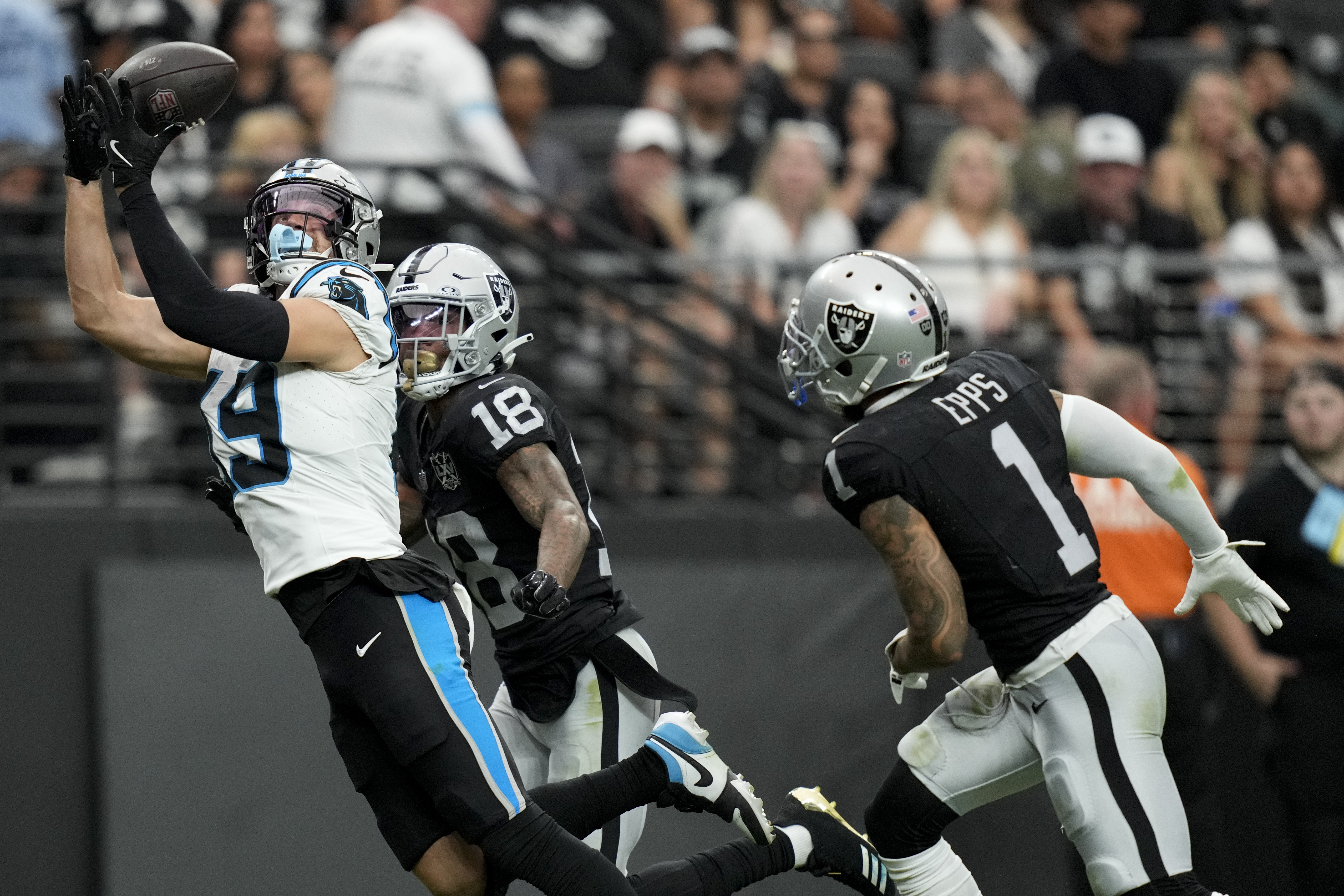Carolina Panthers wide receiver Adam Thielen scores ahead of Las Vegas Raiders cornerback Jack Jones during the first half of an NFL football game, Sunday, Sept. 22, 2024, in Las Vegas.