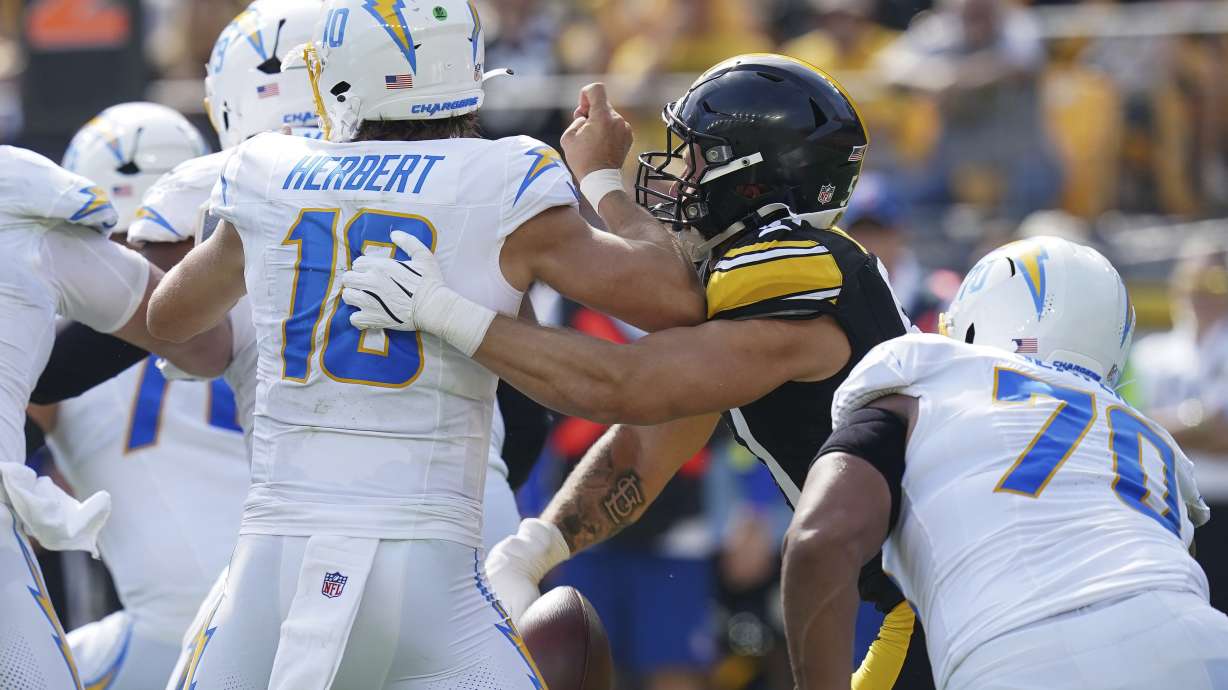 Pittsburgh Steelers linebacker Nick Herbig, second from right, forces a fumble by Los Angeles Chargers quarterback Justin Herbert (10) during the second half of an NFL football game, Sunday, Sept. 22, 2024, in Pittsburgh.