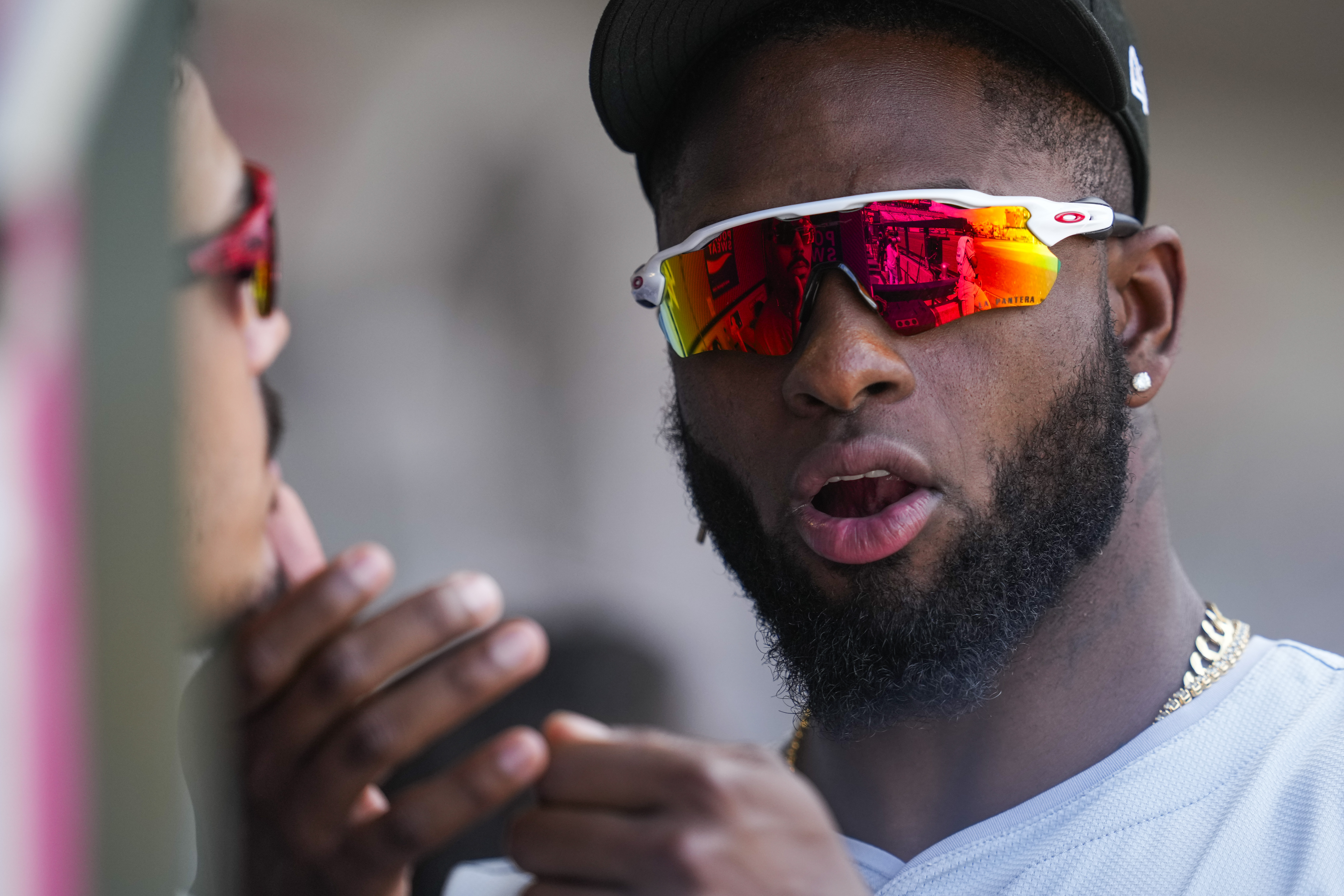 Chicago White Sox outfielder Luis Robert Jr., right, grooms the beard of third baseman Miguel Vargas, left, in the dugout during the third inning of a baseball game against the Los Angeles Angels in Anaheim, Calif., Wednesday, Sept. 18, 2024. 