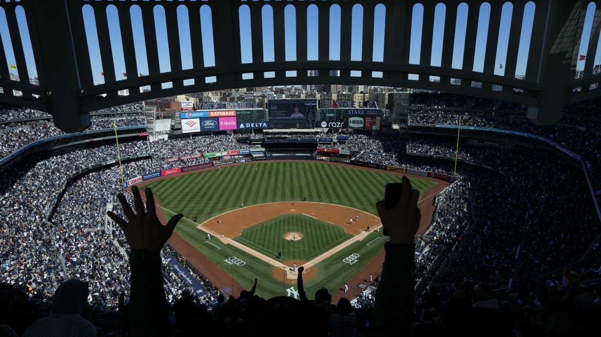 FILE - Fans react after New York Yankees' Aaron Judge hits a home run during the third inning of a baseball game against the San Francisco Giants at Yankee Stadium, Sunday, April 2, 2023, in New York.