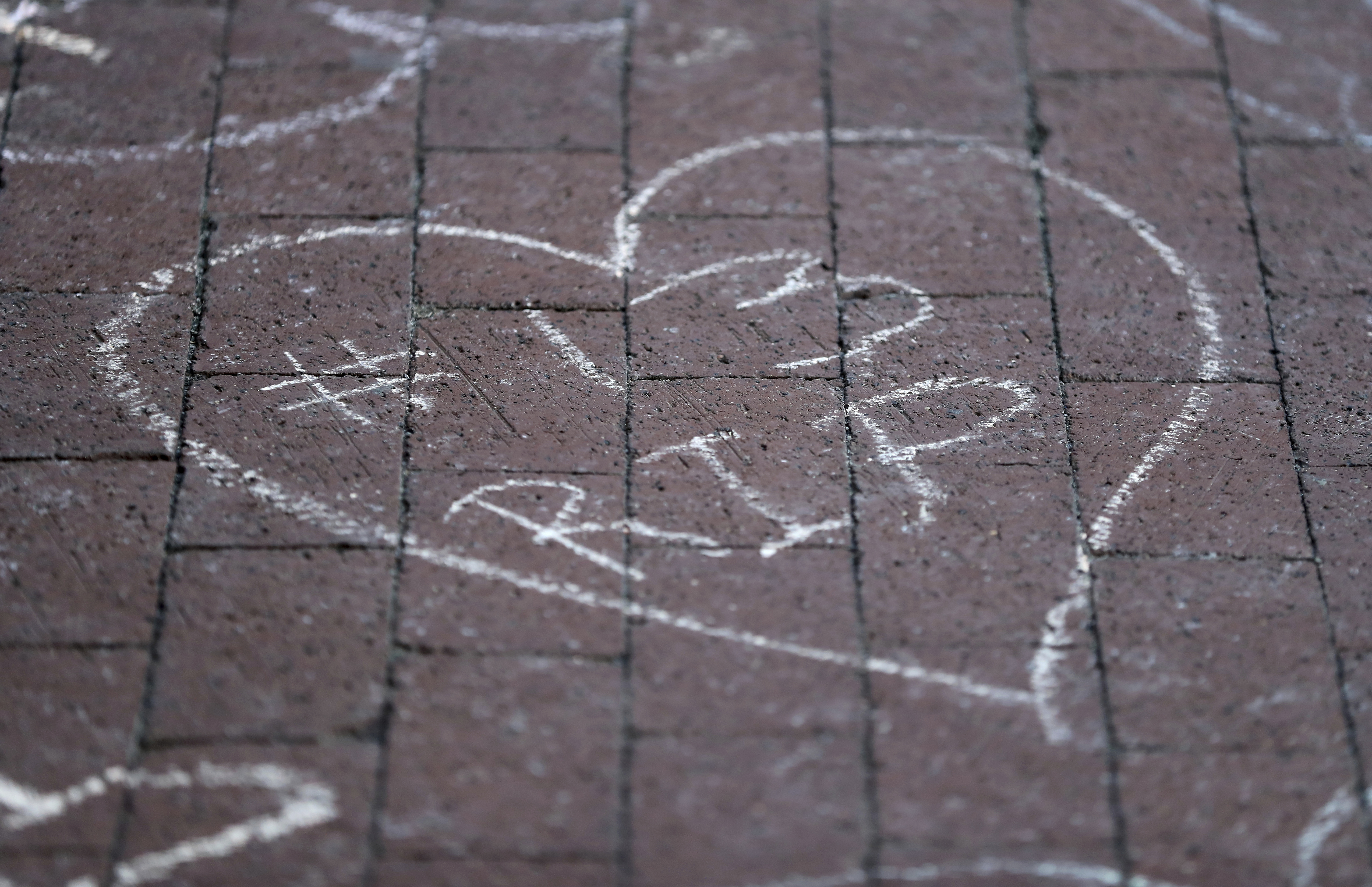 Columbus Blue Jackets fans leave chalk messages during the candlelight vigil to honor Blue Jackets hockey player Johnny Gaudreau, Thursday, Sept. 4, 2024, outside of Nationwide Arena in Columbus, Ohio. Gaudreau and his brother Matthew were killed by a motor vehicle last week while riding bicycles.