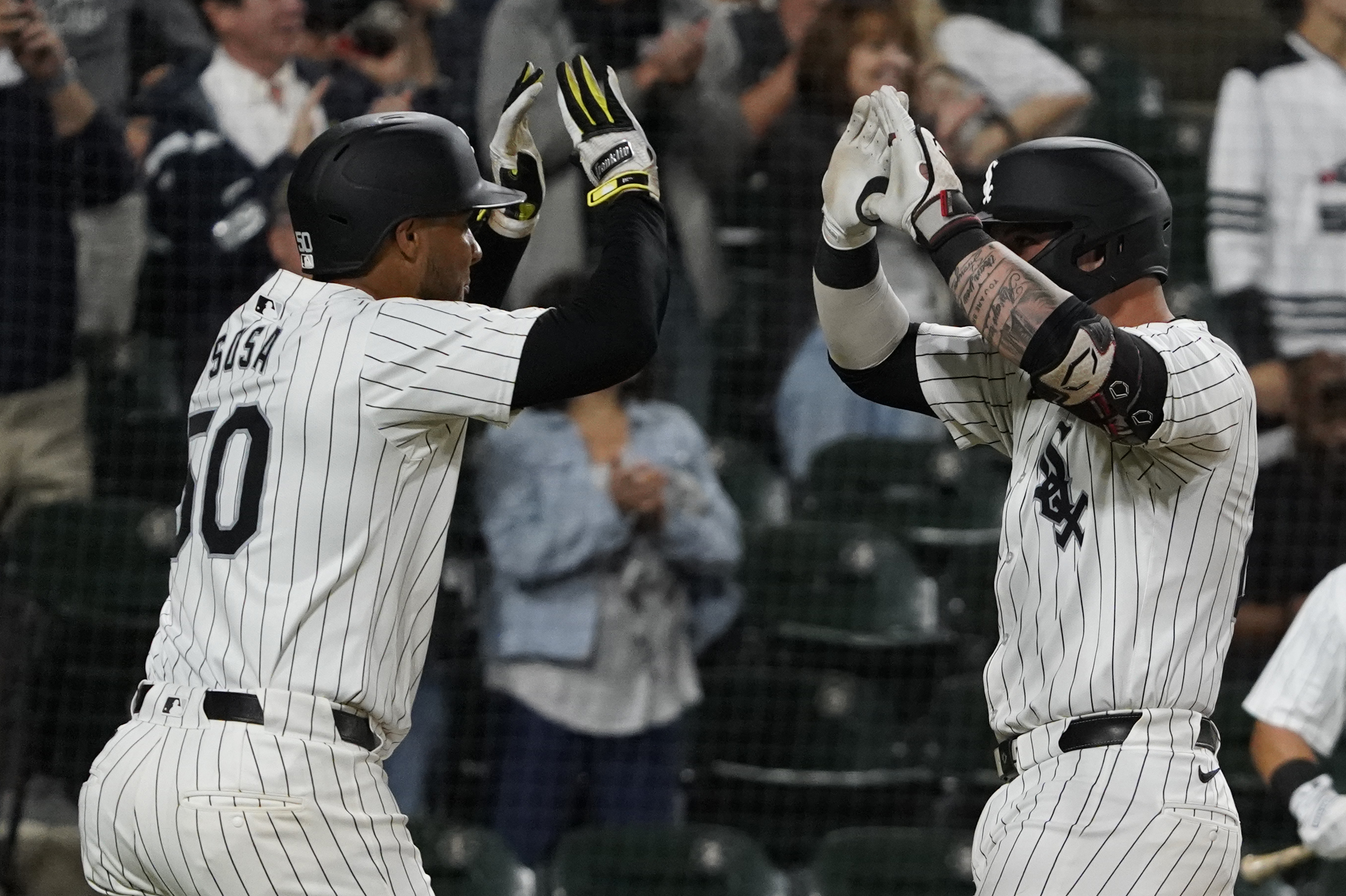 Chicago White Sox's Korey Lee, right, is greeted by Lenyn Sosa, left, after hitting a two-run home run against the Los Angeles Angels during second inning of a baseball game, Wednesday, Sept. 25, 2024, in Chicago. 