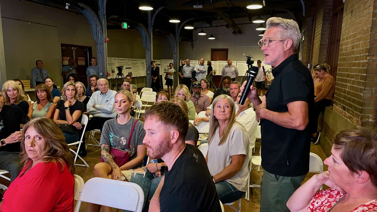 Thomas Hardy, standing, owner of an Ogden hair salon, addresses a meeting on Wednesday on plans to implement paid parking in the downtown area, which have drawn fire from some merchants.