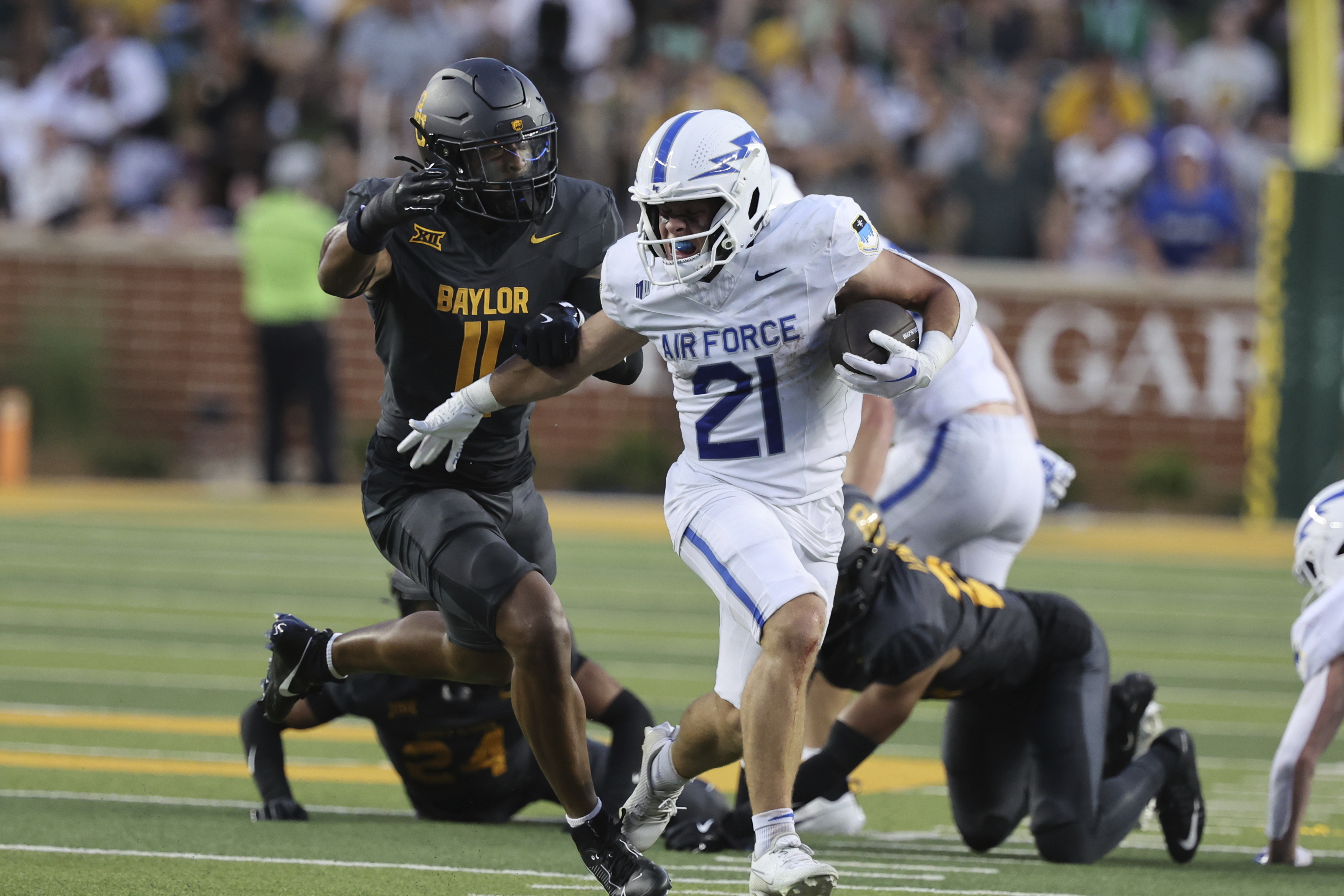 Air Force wide receiver Cade Harris attempts to slip past Baylor linebacker Keaton Thomas during the first half of an NCAA college football game, Saturday, Sept. 14, 2024, in Waco, Texas.
