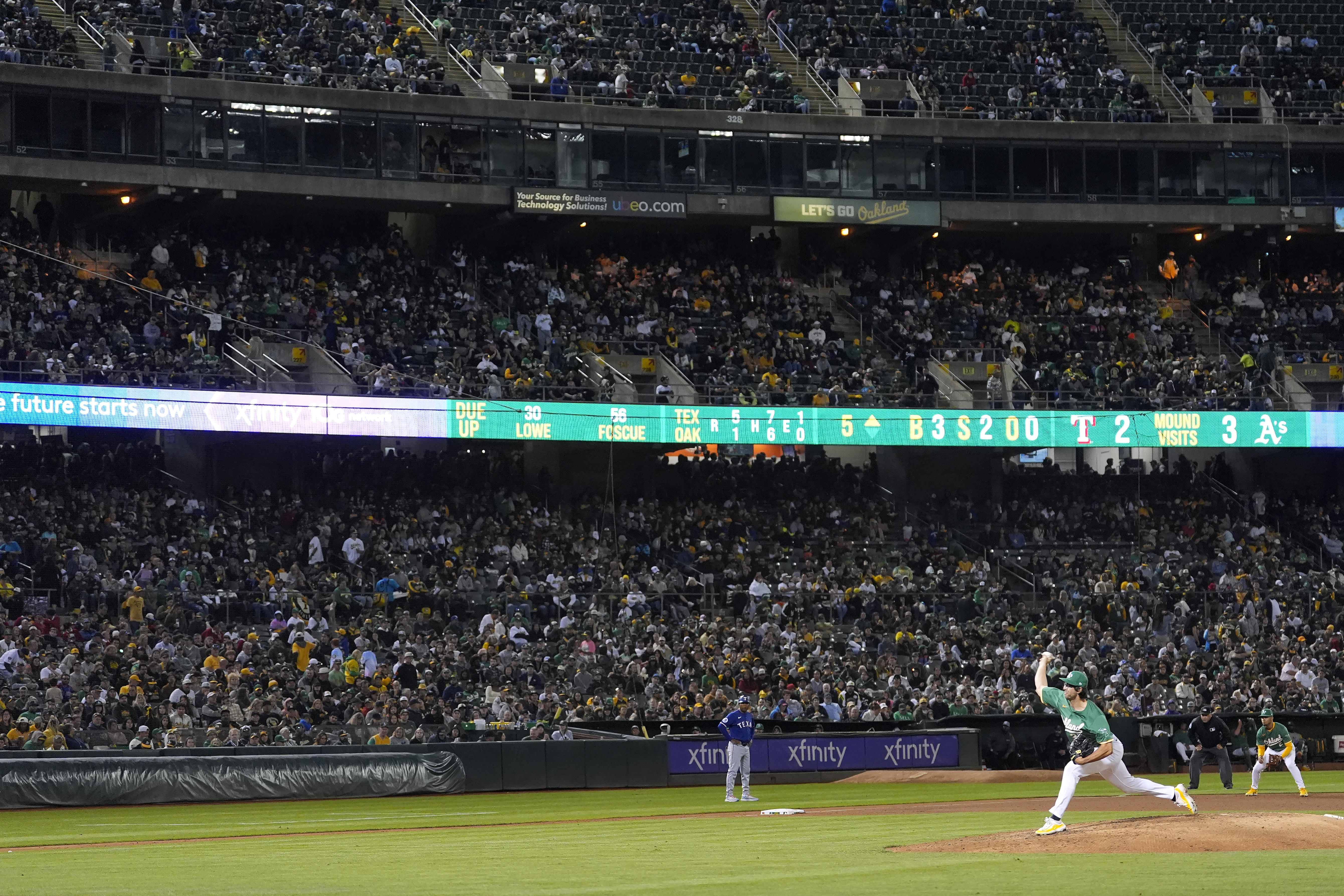 Oakland Athletics pitcher Joe Boyle, bottom, works against the Texas Rangers during the fifth inning of a baseball game in Oakland, Calif., Wednesday, Sept. 25, 2024. 