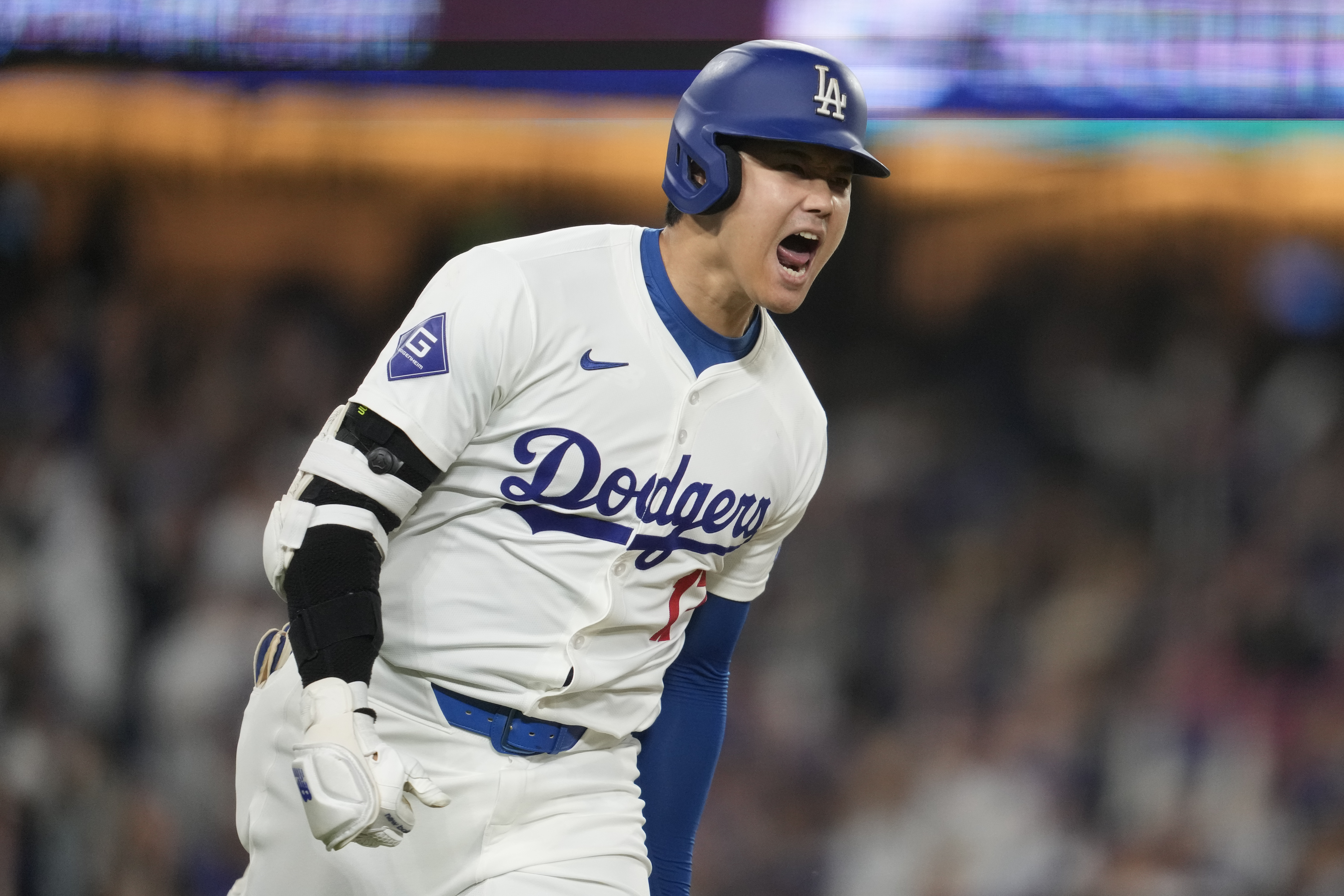 Los Angeles Dodgers designated hitter Shohei Ohtani reacts as he singles during the sixth inning of a baseball game against the San Diego Padres in Los Angeles, Wednesday, Sept. 25, 2024. Will Smith scored. 