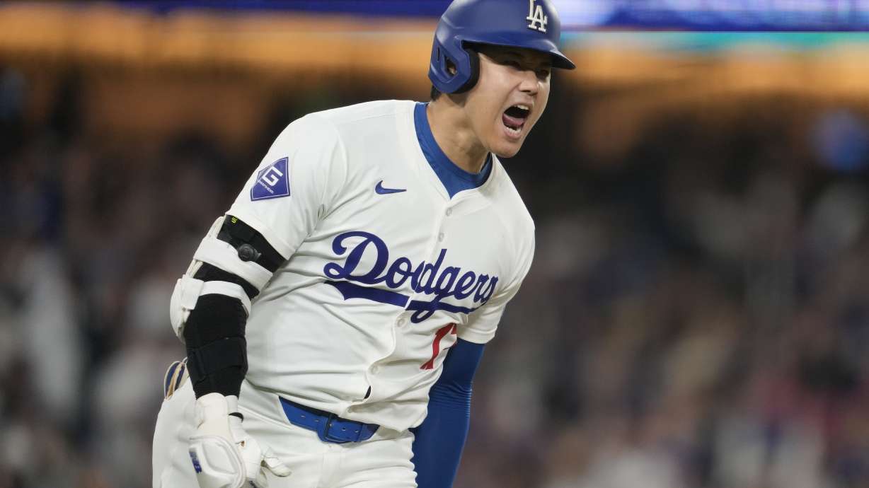 Los Angeles Dodgers designated hitter Shohei Ohtani reacts as he singles during the sixth inning of a baseball game against the San Diego Padres in Los Angeles, Wednesday, Sept. 25, 2024. Will Smith scored.