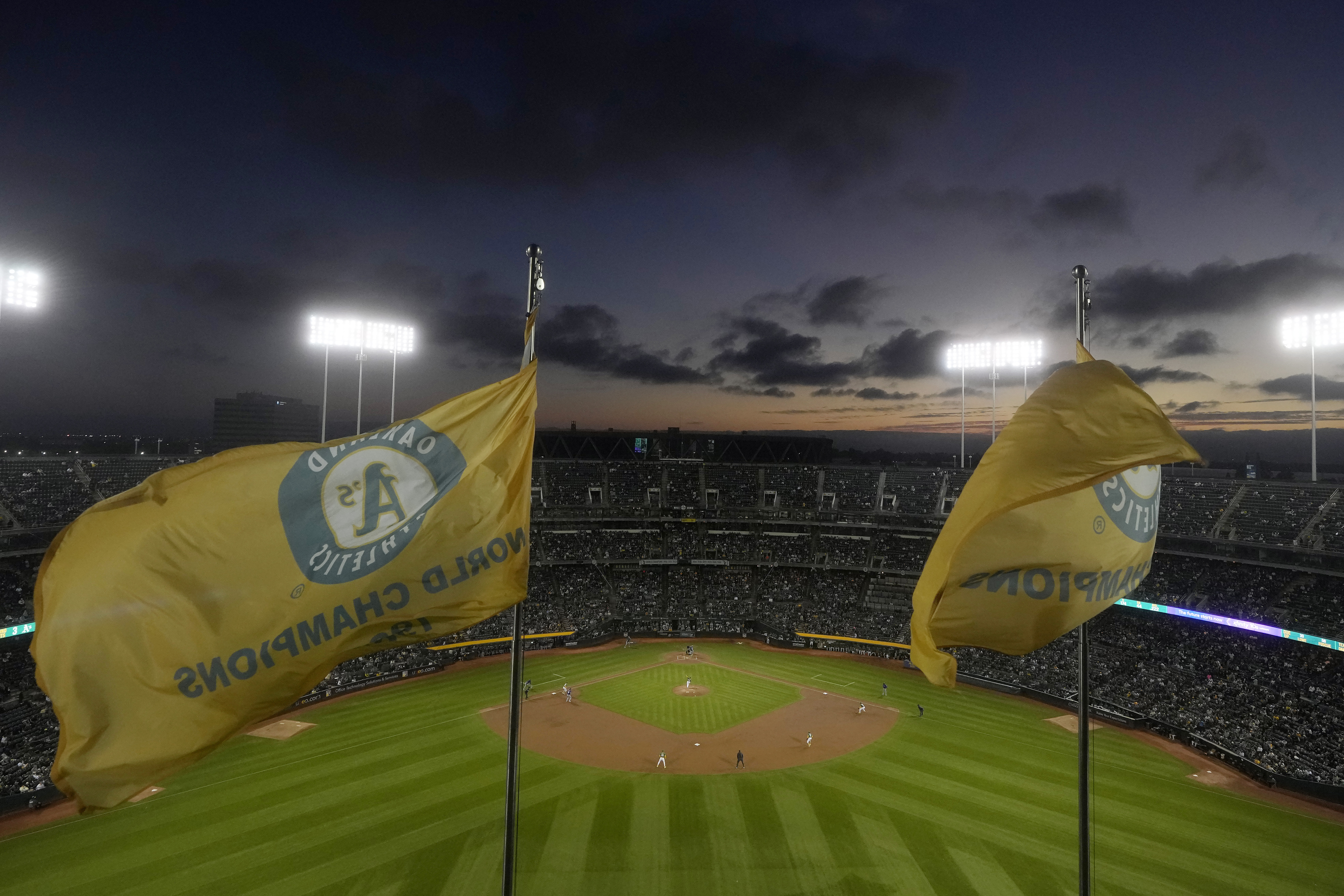 Fans at the Oakland Coliseum watch during the third inning of a baseball game between the Oakland Athletics and the Texas Rangers in Oakland, Calif., Wednesday, Sept. 25, 2024. 