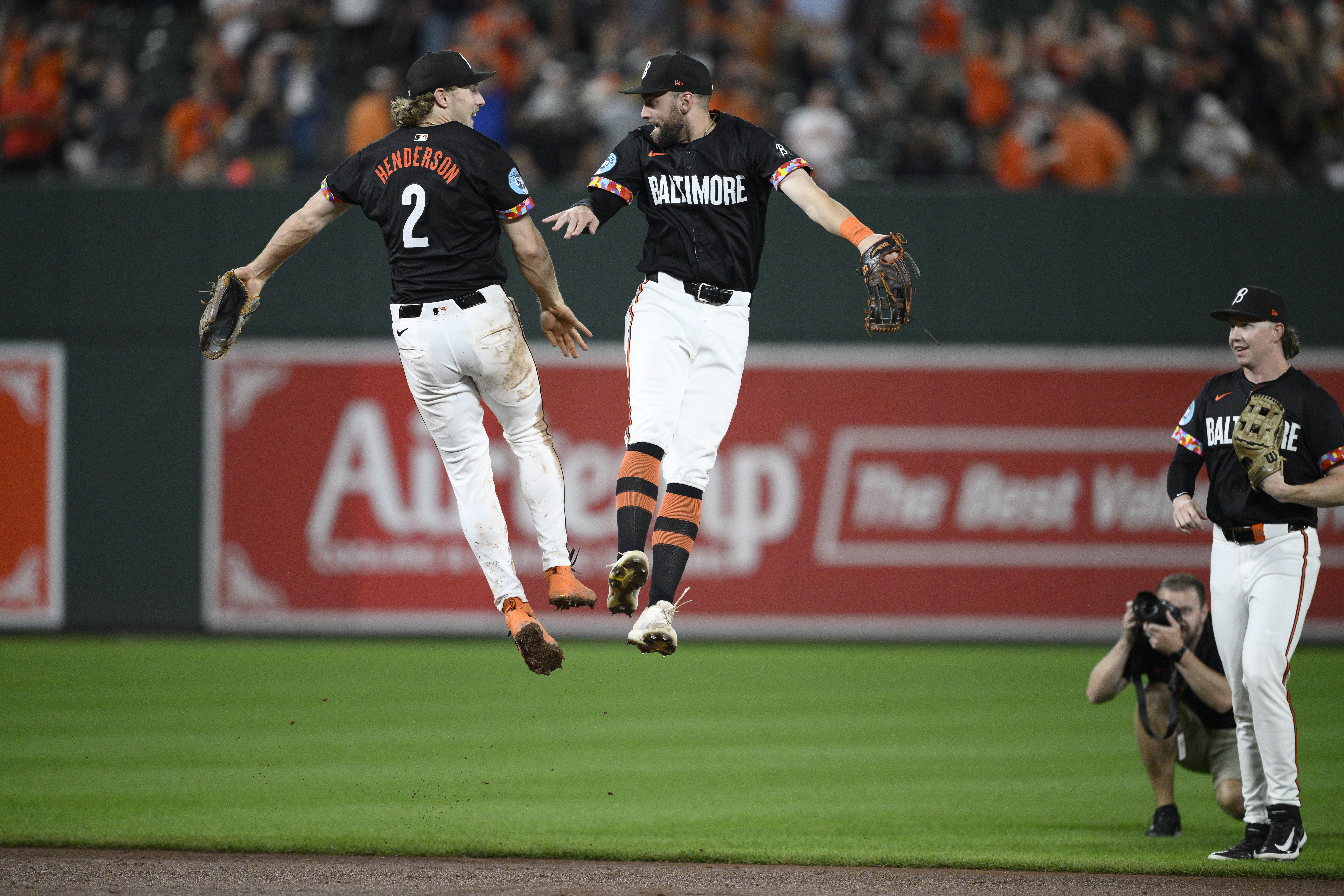 Baltimore Orioles' Gunnar Henderson (2) and Colton Cowser, second from left, and Heston Kjerstad, right, celebrate after a baseball game against the Detroit Tigers, Friday, Sept. 20, 2024, in Baltimore. 