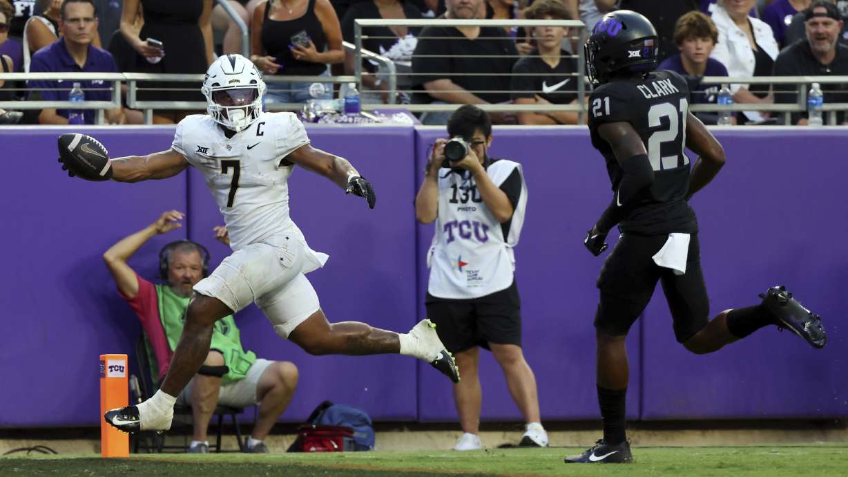 Central Florida running back RJ Harvey (7) scores a touchdown against TCU safety Bud Clark (21) in the second quarter during an NCAA college football game Saturday, Sept. 14, 2024, in Fort Worth, Texas.