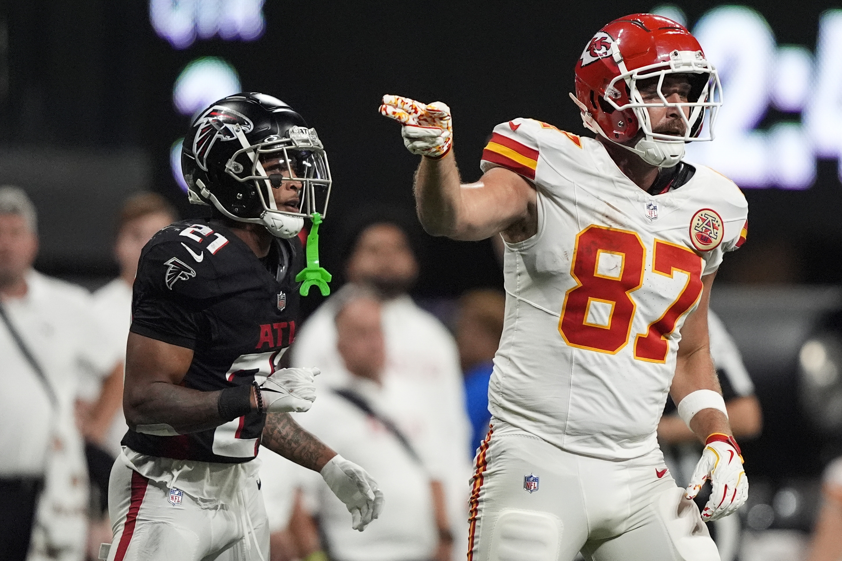 Kansas City Chiefs tight end Travis Kelce (87) celebrates a catch against Atlanta Falcons cornerback Mike Hughes (21) during the second half of an NFL football game, Sunday, Sept. 22, 2024, in Atlanta. 