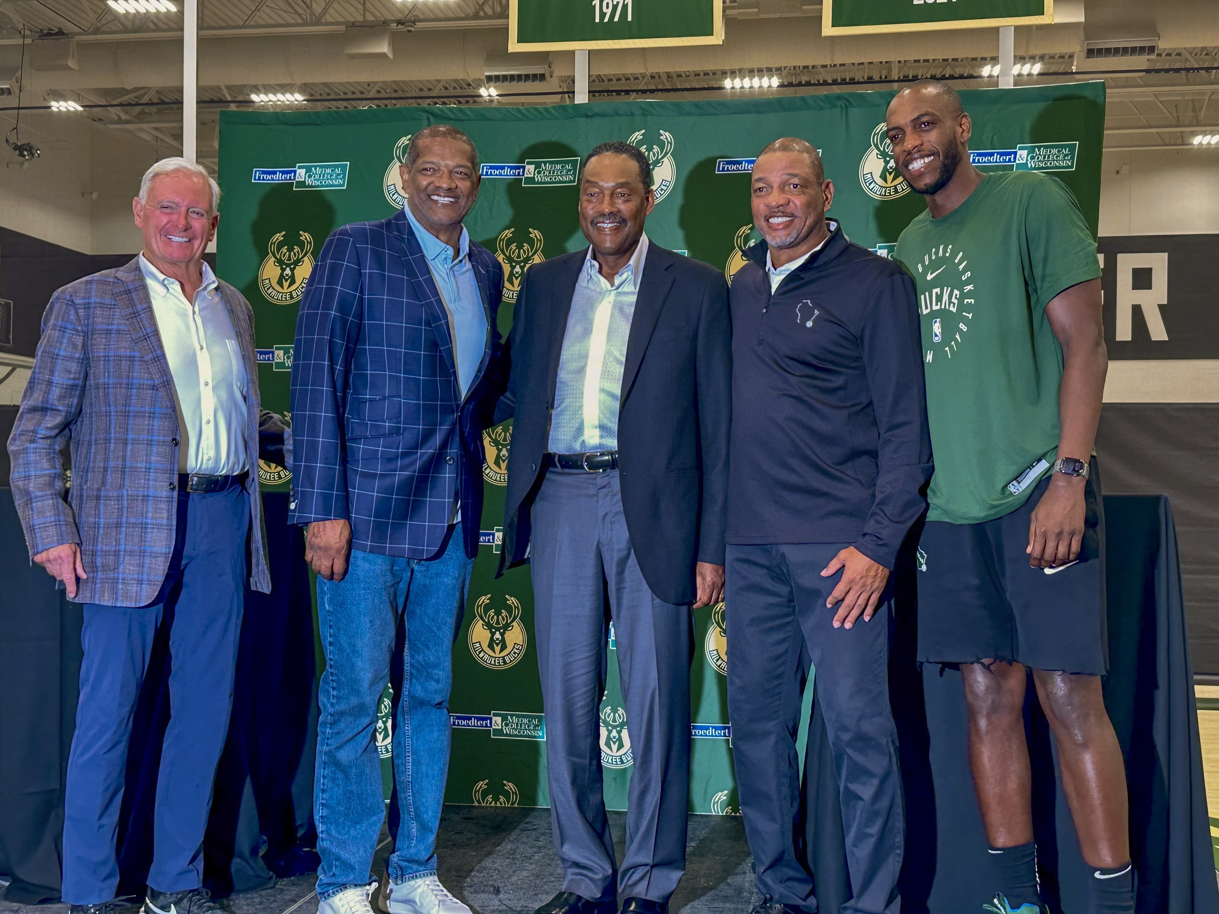 Former Milwaukee Bucks player Junior Bridgeman, center, stands with, from left, co-owner Jimmy Haslam, broadcaster Marques Johnson, coach Doc Rivers and player Khris Middleton after a press conference announcing his purchase in a minority stake of the NBA franchise Thursday, Sept. 26, 2024, in Milwaukee.