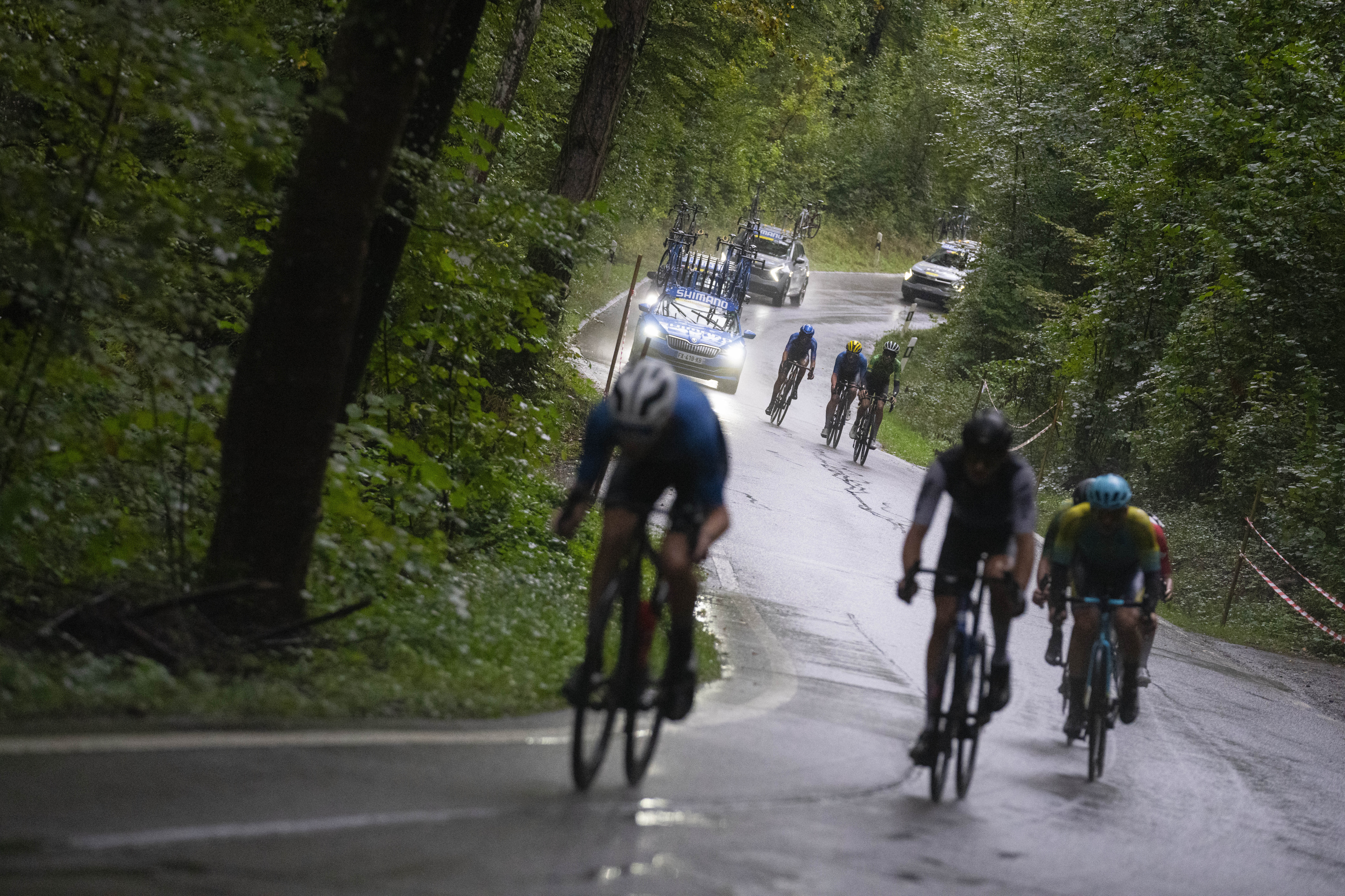 Riders are distanced by the pack in pouring rain during the Men Junior Road Race of the Cycling and Para-cycling Road World Championships in Zurich, Switzerland, Thursday, Sept. 26, 2024.