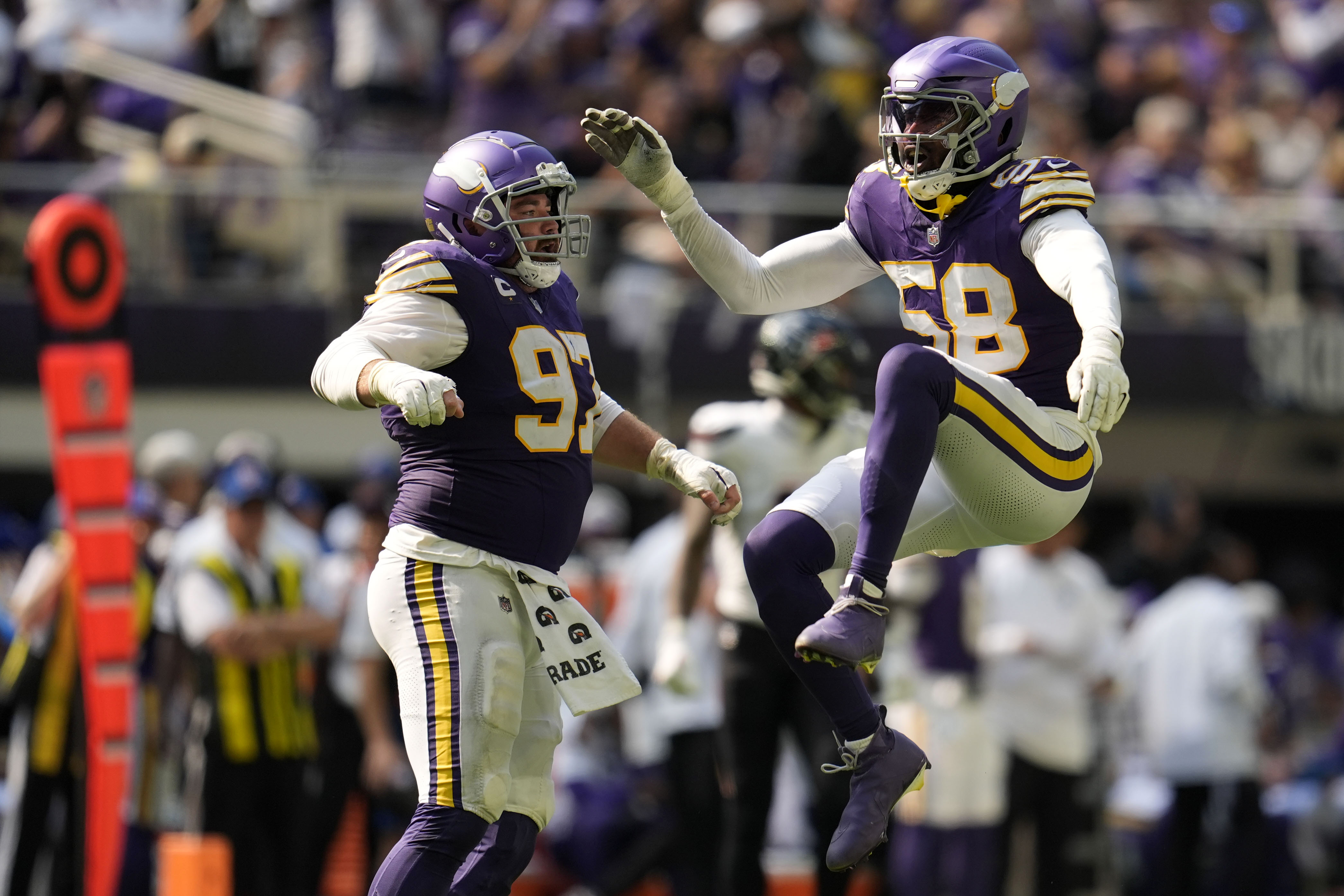 Minnesota Vikings linebacker Jonathan Greenard (58) celebrates with teammate Harrison Phillips (97) after sacking Houston Texans quarterback C.J. Stroud during the second half of an NFL football game, Sunday, Sept. 22, 2024, in Minneapolis.