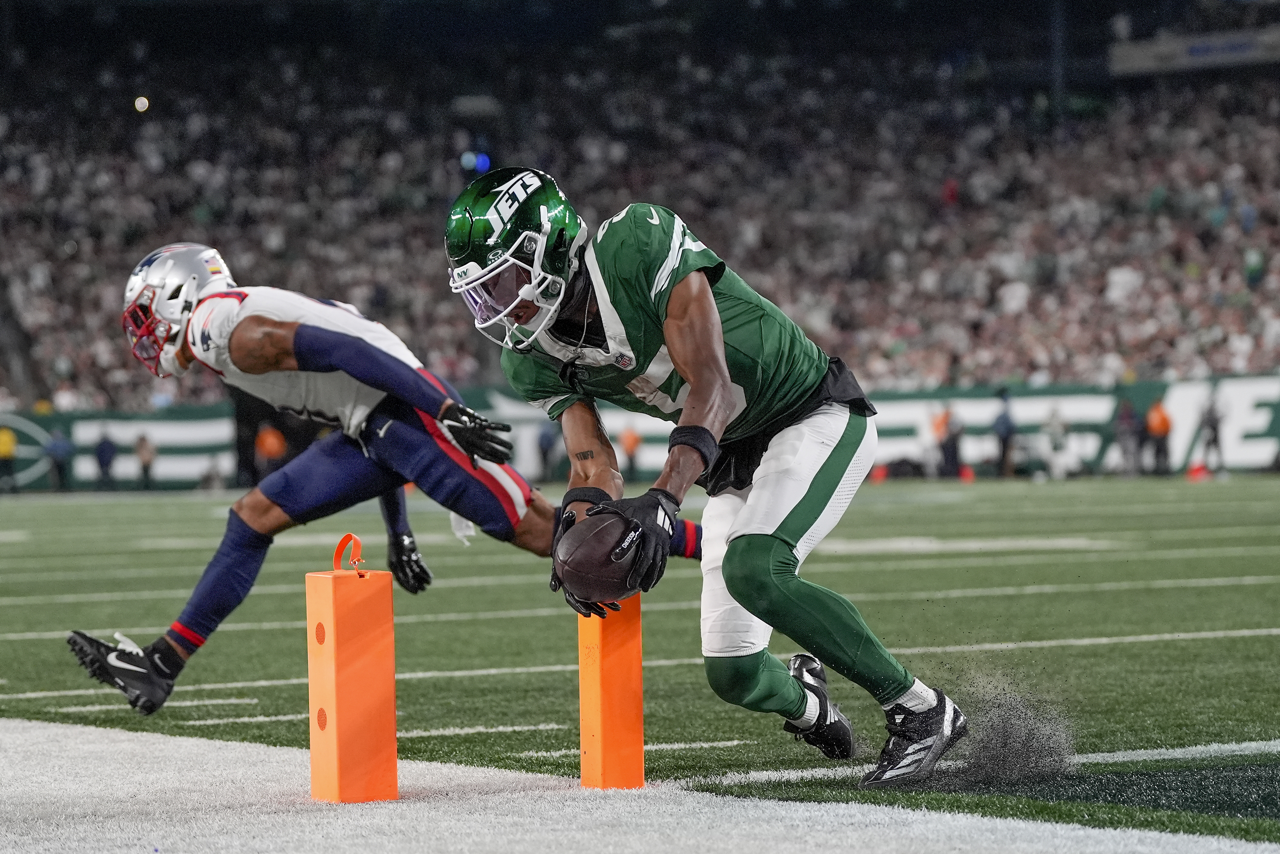 New York Jets wide receiver Garrett Wilson (5) scores a touchdown against the New England Patriots during the third quarter of an NFL football game, Thursday, Sept. 19, 2024, in East Rutherford, N.J. 