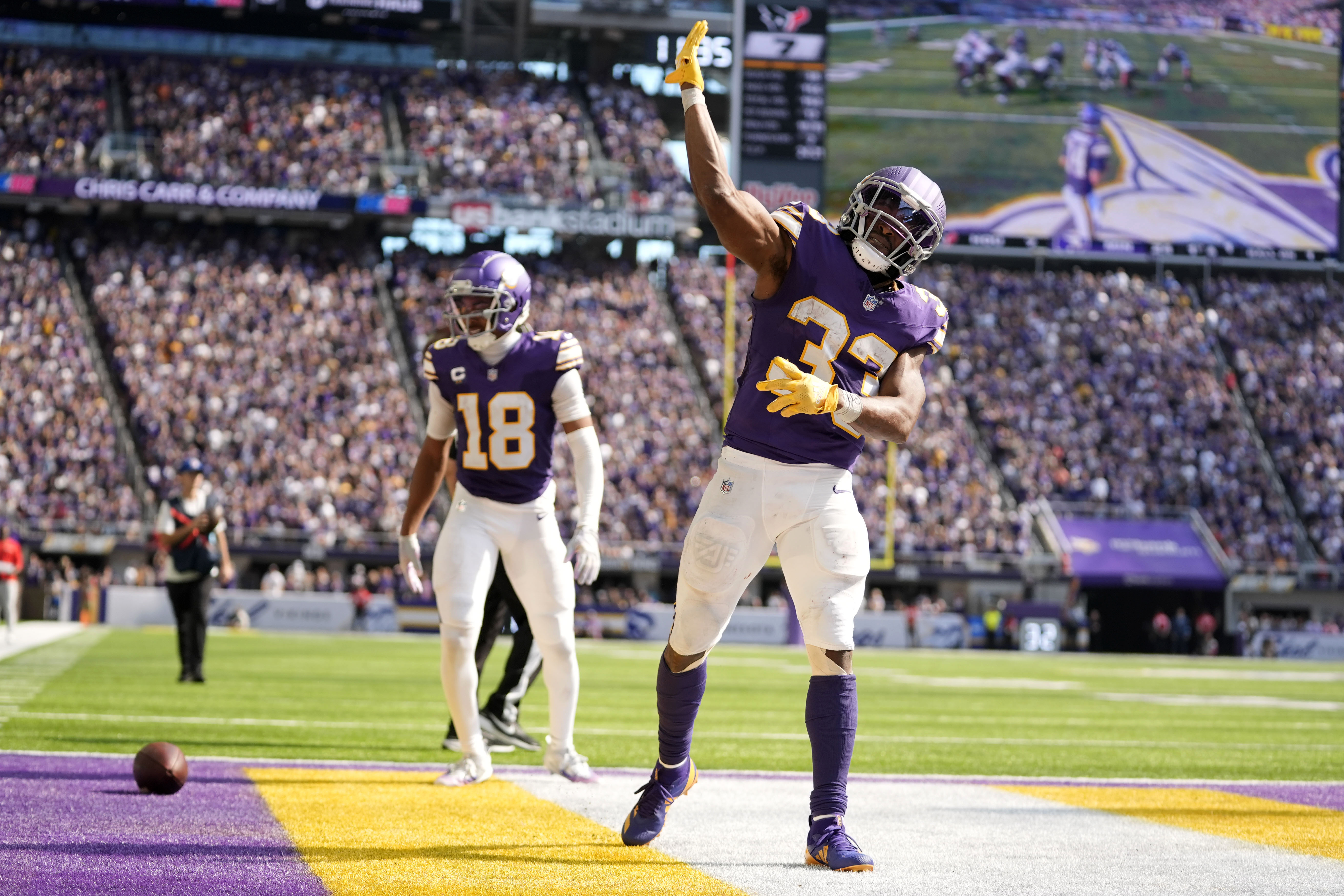 Minnesota Vikings running back Aaron Jones (33) celebrates after a 39-yard run during the second half of an NFL football game against the Houston Texans, Sunday, Sept. 22, 2024, in Minneapolis.