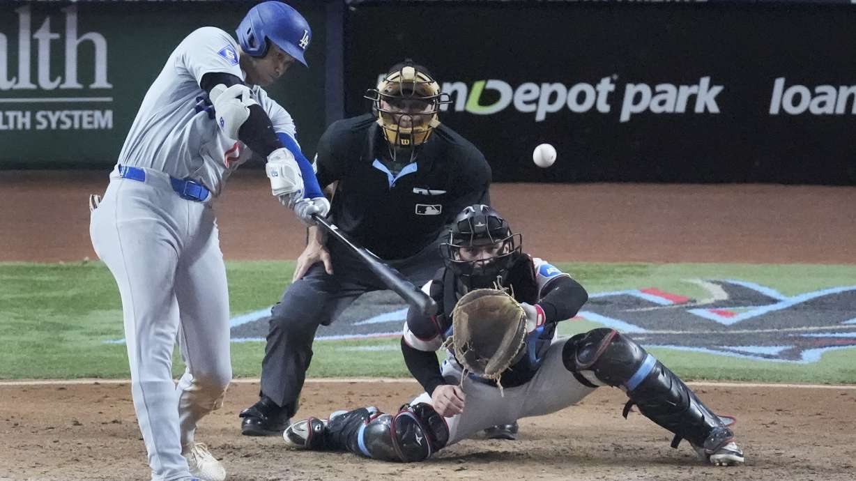 Los Angeles Dodgers' Shohei Ohtani (17) hits a home run scoring Andy Pages, during the seventh inning of a baseball game against the Miami Marlins, Thursday, Sept. 19, 2024, in Miami.