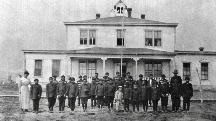 Boys lined up in front of White Rocks Indian School in their uniforms in an undated photo. An event honor Native American children to attend such schools is set for Saturday.