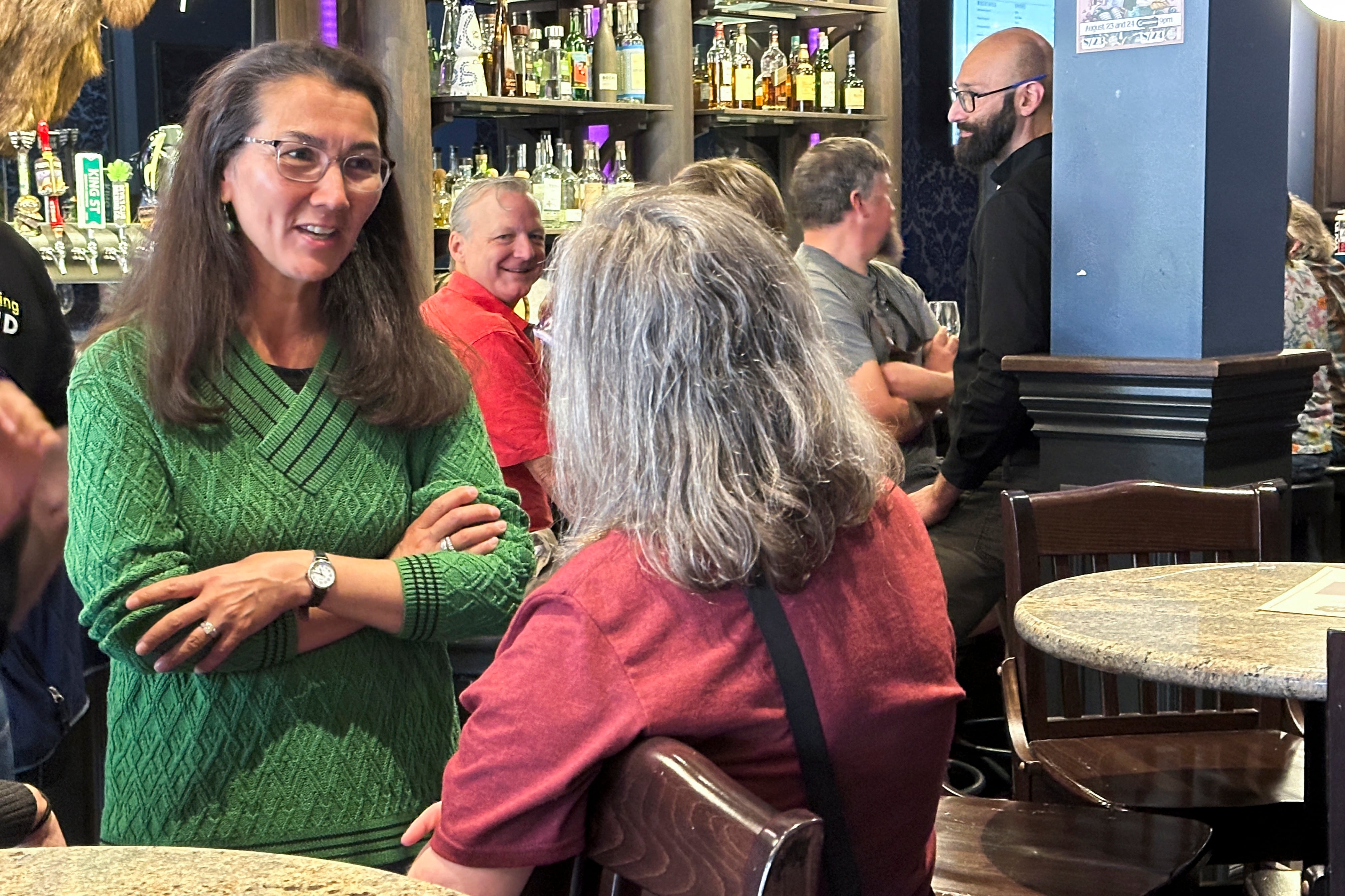 Alaska U.S. Rep. Mary Peltola, left, speaks to a woman at a campaign event at a bar in downtown Juneau, Alaska, on Aug. 3. The House majority may be decided in the West.