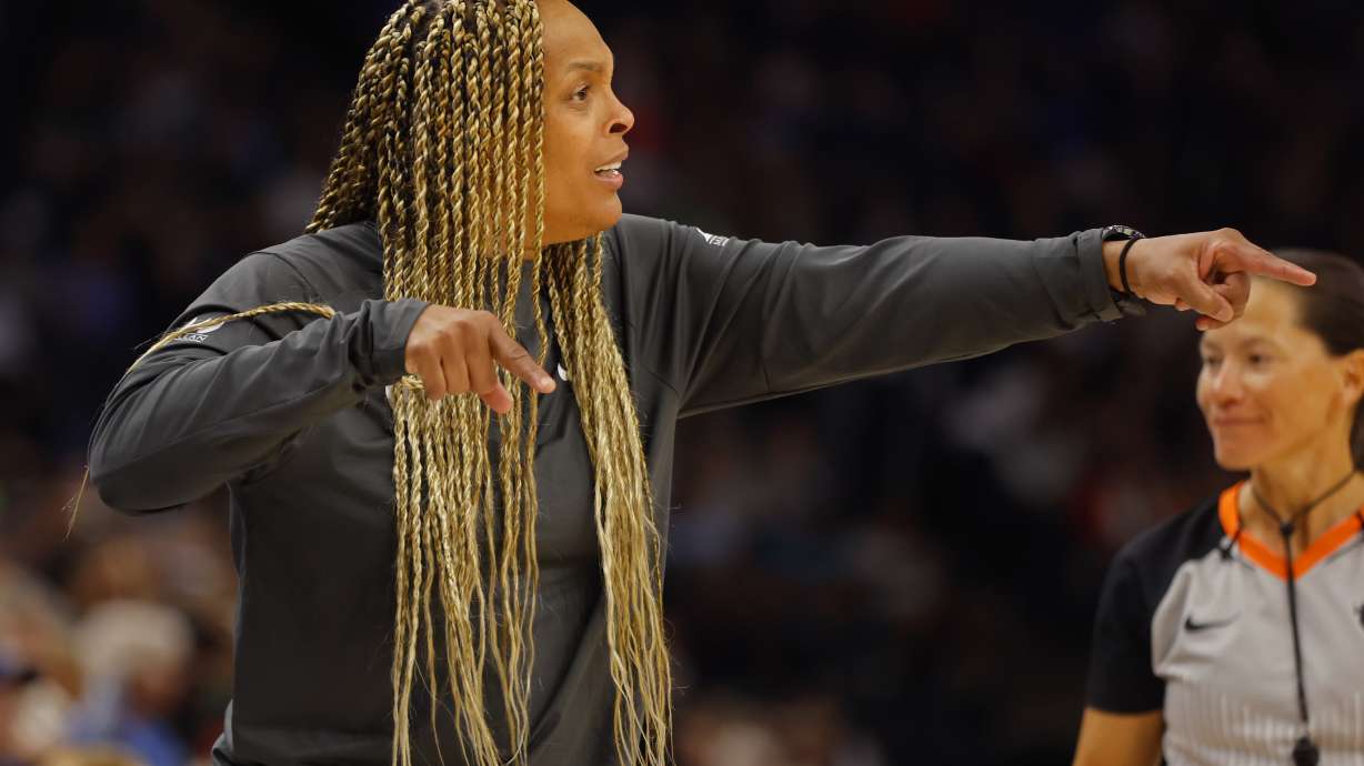 Chicago Sky head coach Teresa Weatherspoon, left, directs her team as they play the Minnesota Lynx in the second quarter of a WNBA basketball game Friday, Sept. 13, 2024, in Minneapolis.