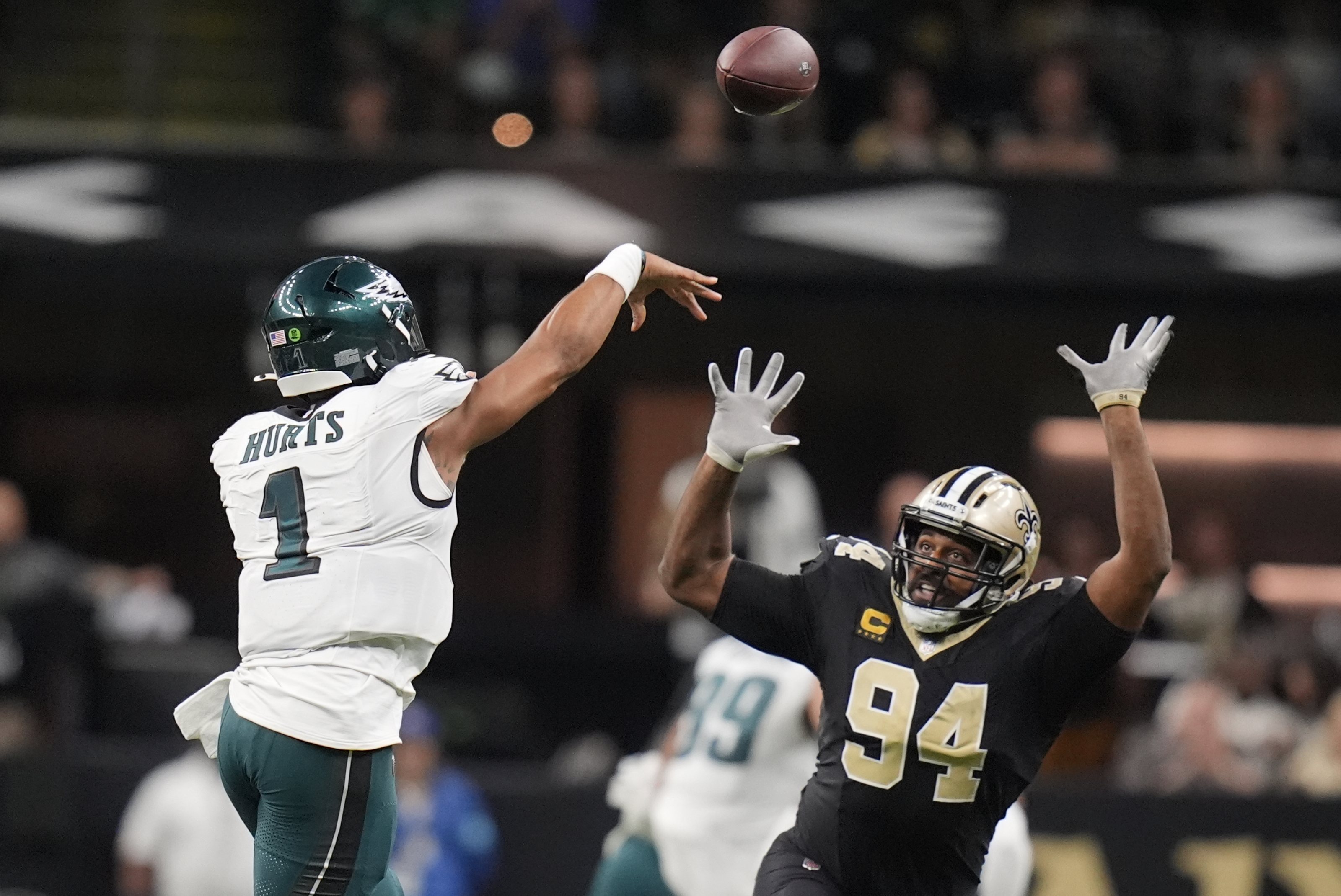 Philadelphia Eagles quarterback Jalen Hurts (1) passes over the reach of New Orleans Saints defensive end Cameron Jordan (94) in the second half of an NFL football game in New Orleans, Sunday, Sept. 22, 2024. 