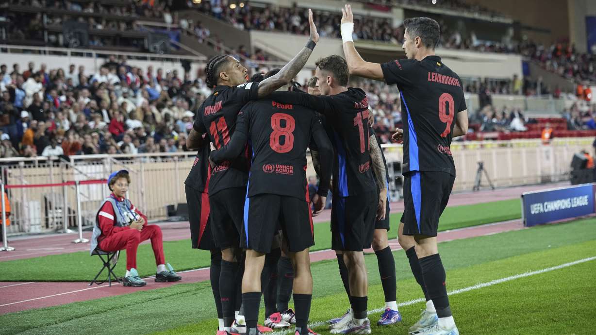 Barcelona's players celebrate after their teammate Lamine Yamal scored his side's opening goal during the Champions League opening phase soccer match between Monaco and Barcelona at the Louis II stadium, in Monaco, Monaco, Thursday, Sept. 19, 2024.