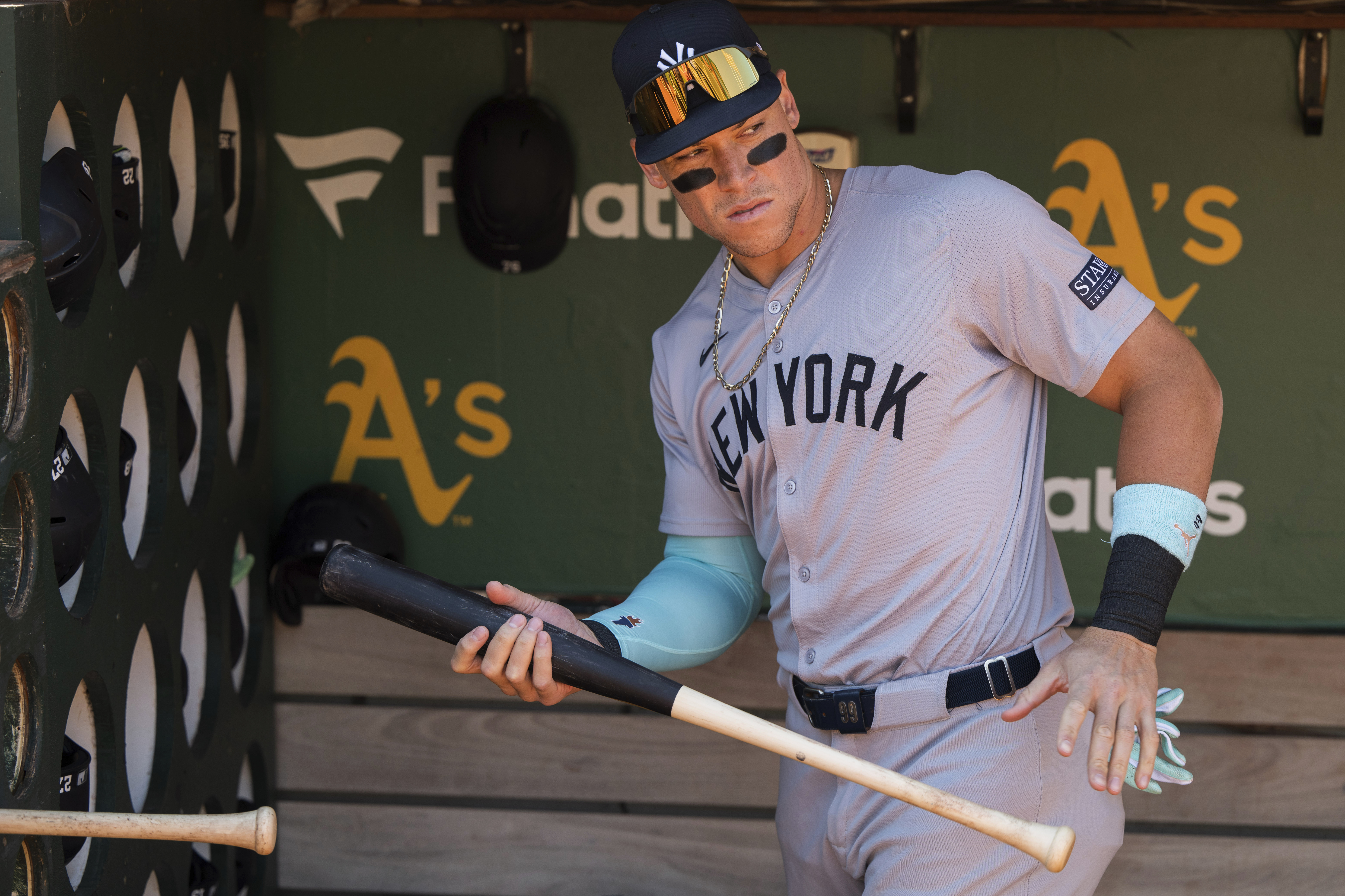 New York Yankees' Aaron Judge grabs a bat from the dugout before a baseball game against the Oakland Athletics in Oakland, Calif., Sunday, Sept. 22, 2024. 