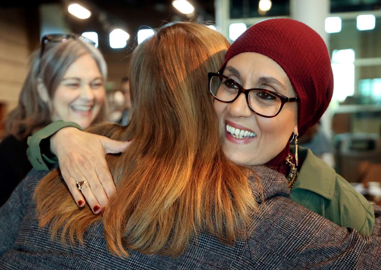 Rachel Miner, Bellwether International founder and CEO, hugs Dr. Debbie Almontaser, Bridging Cultures Group CEO and president, at the second annual Bridging Religious Divides Symposium at the Utah Cultural Celebration Center in West Valley City on Thursday.