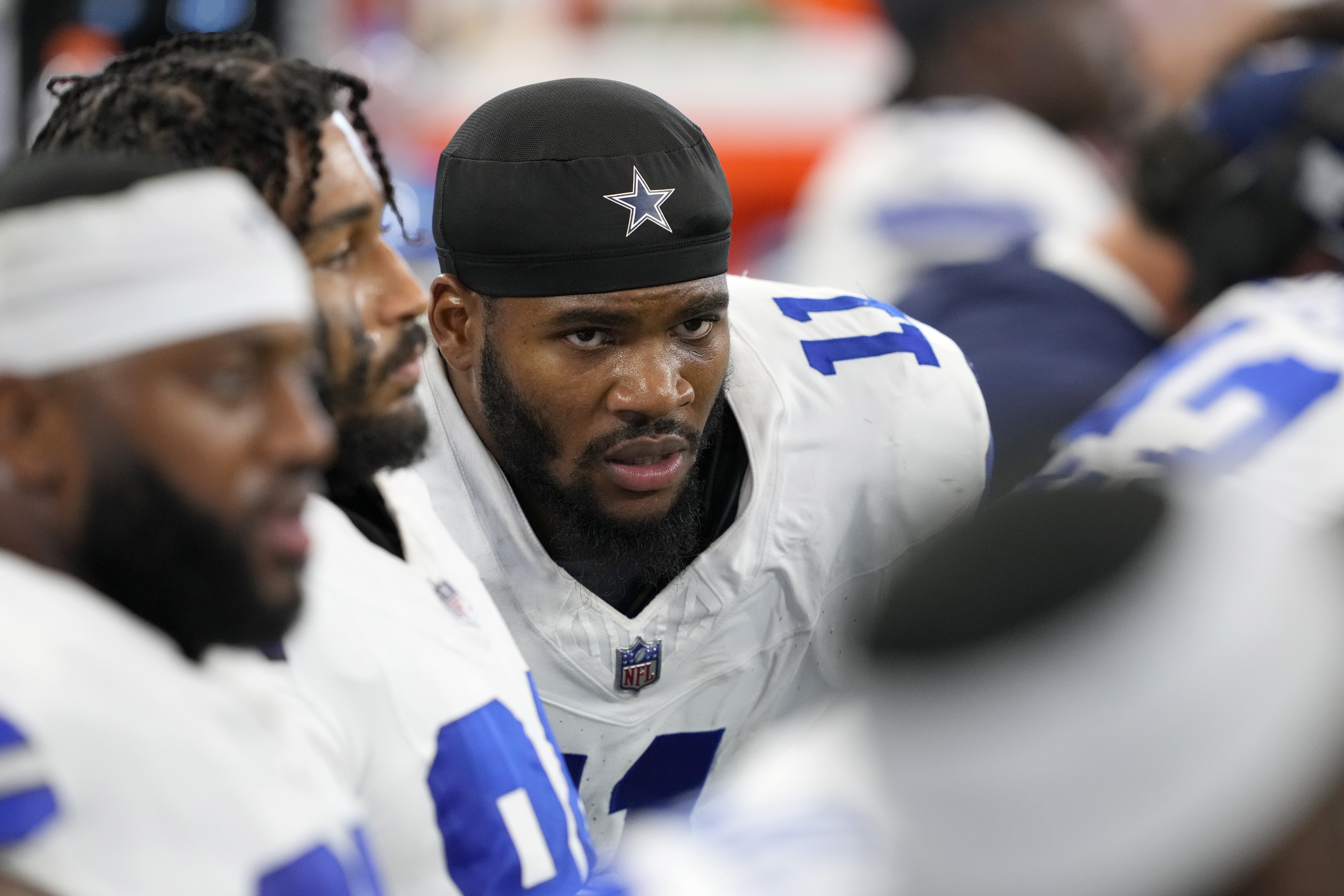 Dallas Cowboys linebacker Micah Parsons (11) sits on the bench alongside teammates in the second half of an NFL football game against the Baltimore Ravens in Arlington, Texas, Sunday, Sept. 22, 2024.