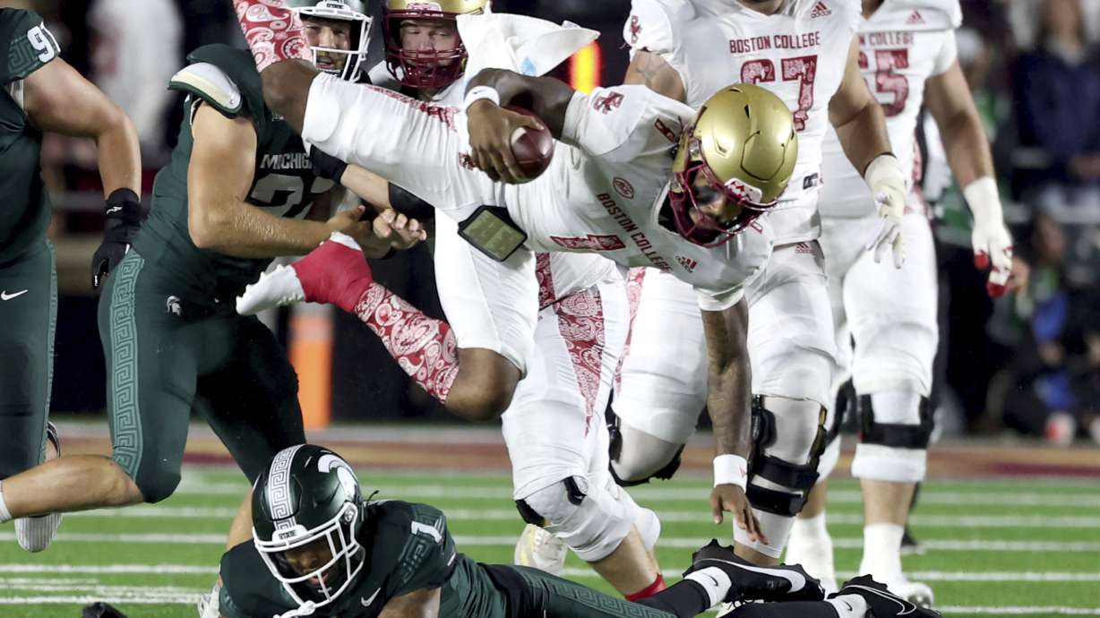 Boston College quarterback Thomas Castellanos (1) is upended by Michigan State defensive back Nikai Martinez (1) during the first half of an NCAA college football game Saturday, Sept. 21, 2024, in Boston.