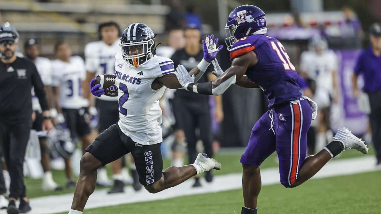 Adrian Comier using a stiff arm against Portland State.