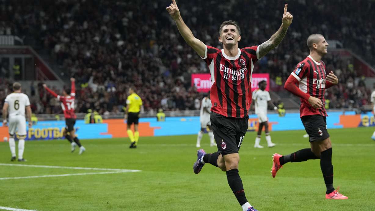 AC Milan's Christian Pulisic celebrates after he scored during the Serie A soccer match between AC Milan and Lecce at the San Siro stadium in Milan, Italy, Friday, Sept. 27, 2024.