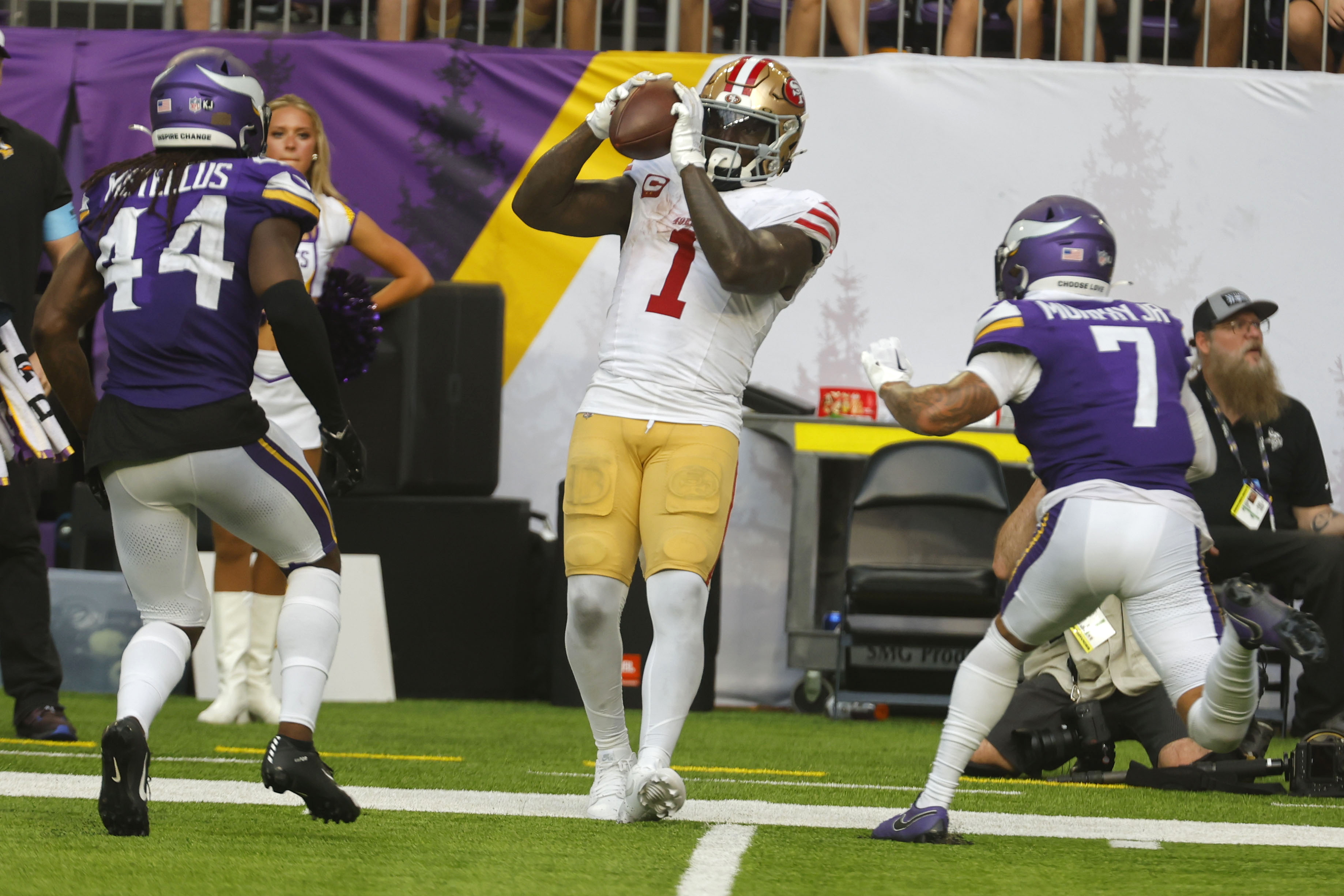 San Francisco 49ers wide receiver Deebo Samuel Sr. (1) catches a pass between Minnesota Vikings safety Josh Metellus (44) and cornerback Byron Murphy Jr. (7) during the second half of an NFL football game, Sunday, Sept. 15, 2024, in Minneapolis. 