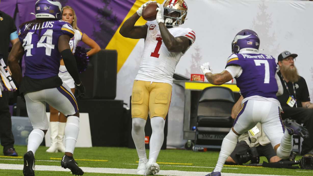 San Francisco 49ers wide receiver Deebo Samuel Sr. (1) catches a pass between Minnesota Vikings safety Josh Metellus (44) and cornerback Byron Murphy Jr. (7) during the second half of an NFL football game, Sunday, Sept. 15, 2024, in Minneapolis.