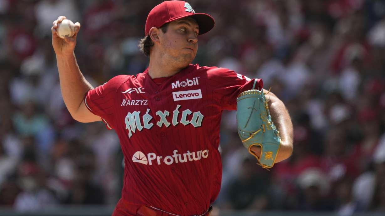 FILE - Diablos Rojos' pitcher Trevor Bauer throws against New York Yankees' Anthony Volpe during the first inning of a baseball exhibition game at Alfredo Harp Helu Stadium in Mexico City, Sunday, March 24, 2024.