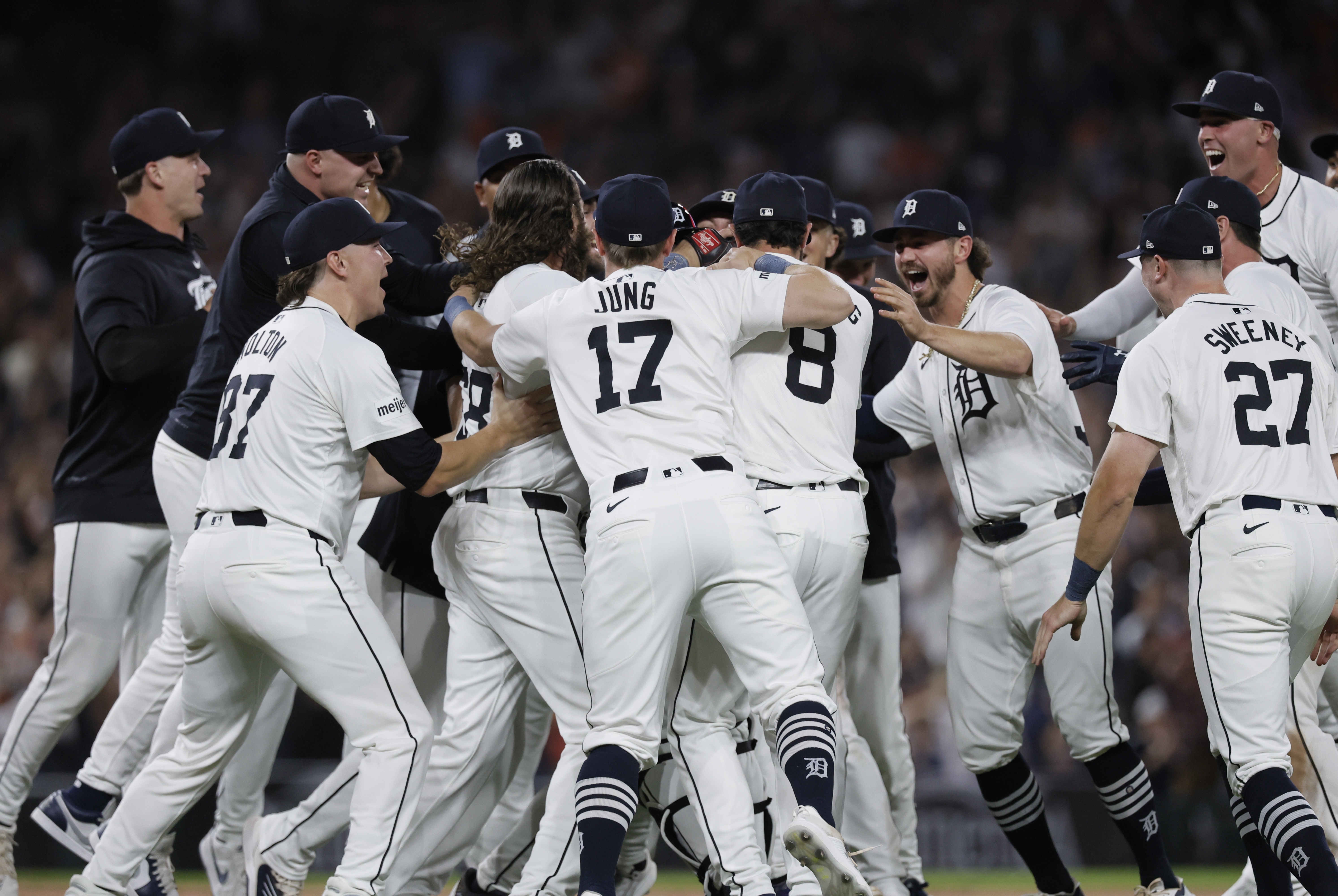 The Detroit Tigers, including Tyler Holton (87), Jace Jung (17), Matt Vierling (8), Zach McKinstry, Trey Sweeney (27) and Kerry Carpenter, celebrate after defeating the Chicago White Sox to win a wildcard spot in the major league baseball playoffs, Friday, Sept. 27, 2024, in Detroit. 