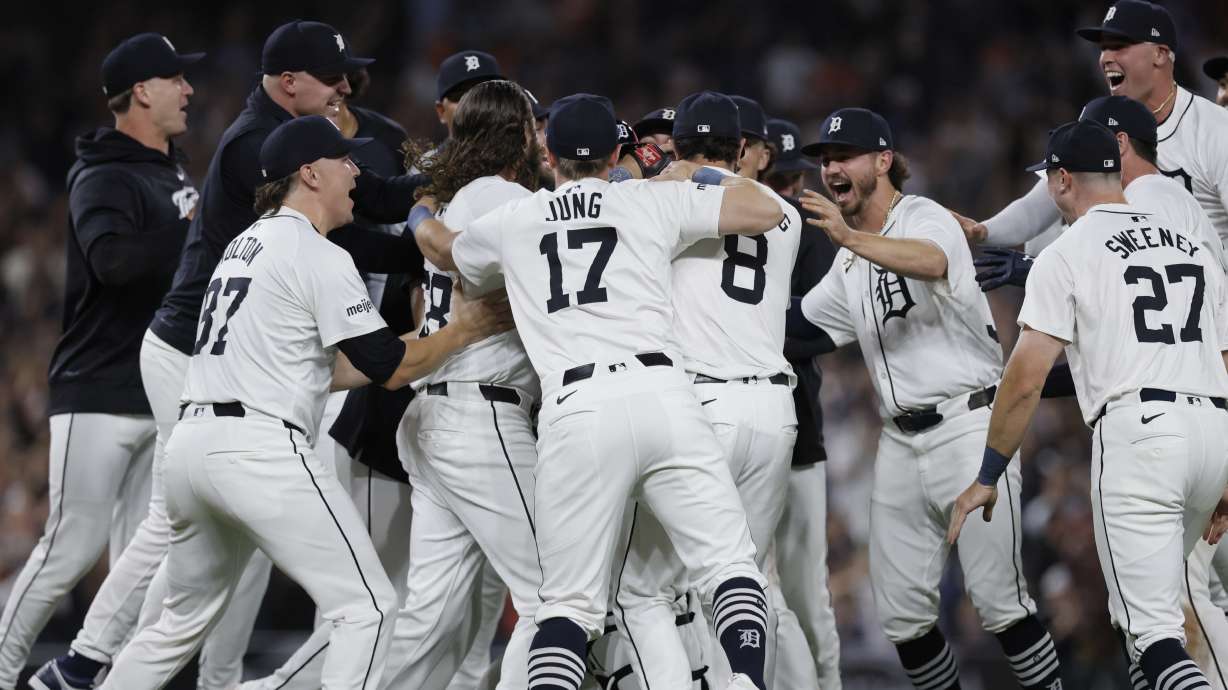 The Detroit Tigers, including Tyler Holton (87), Jace Jung (17), Matt Vierling (8), Zach McKinstry, Trey Sweeney (27) and Kerry Carpenter, celebrate after defeating the Chicago White Sox to win a wildcard spot in the major league baseball playoffs, Friday, Sept. 27, 2024, in Detroit.