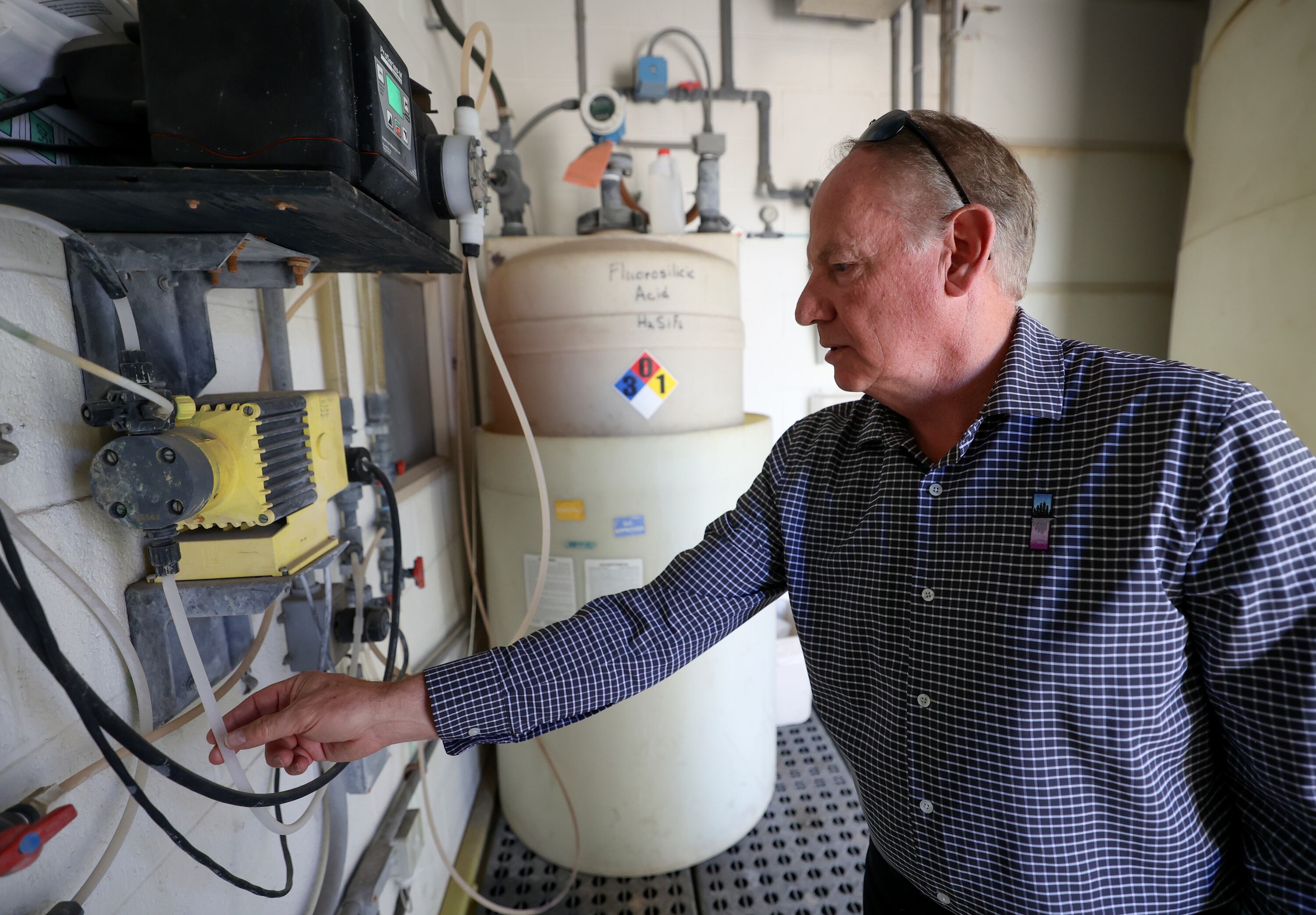 Scott Paxman, Weber Water Basin Conservancy District general manager and CEO, shows how the fluoridation station works at the Fairfield Well in Layton on Friday.