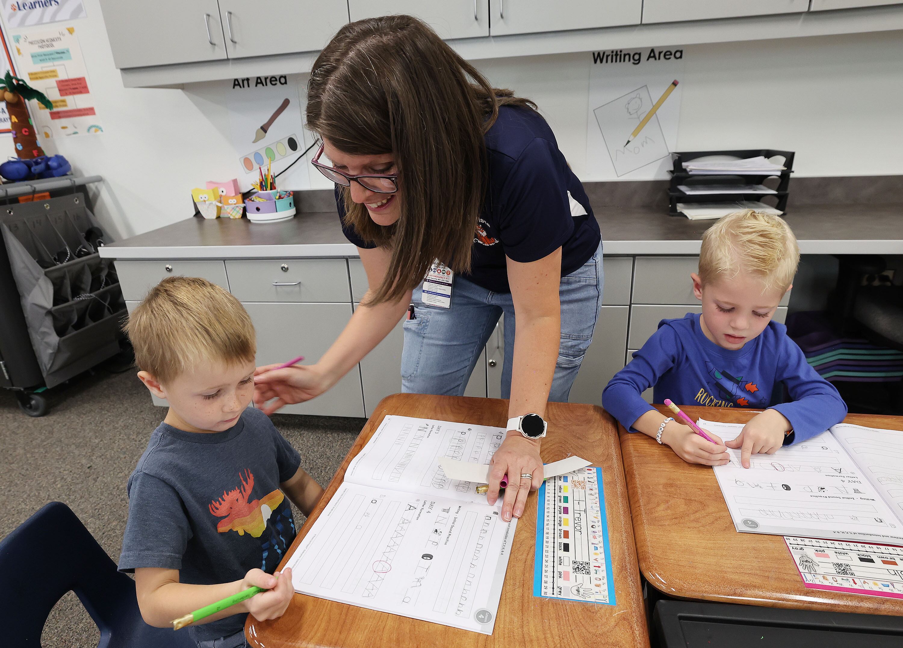 Bella Vista Elementary kindergarten teacher Tamara Coombs works with students Trevor Allen and Lincoln Snow in Cottonwood Heights on Tuesday.