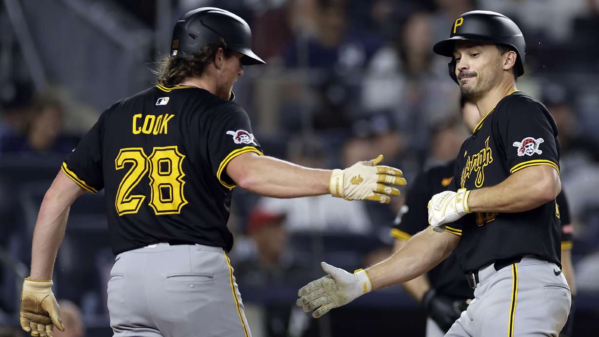 Pittsburgh Pirates' Bryan Reynolds, right, is greeted Billy Cook (28) after hitting a two-run home run during the eighth inning of a baseball game against the New York Yankees, Friday, Sept. 27, 2024, in New York.