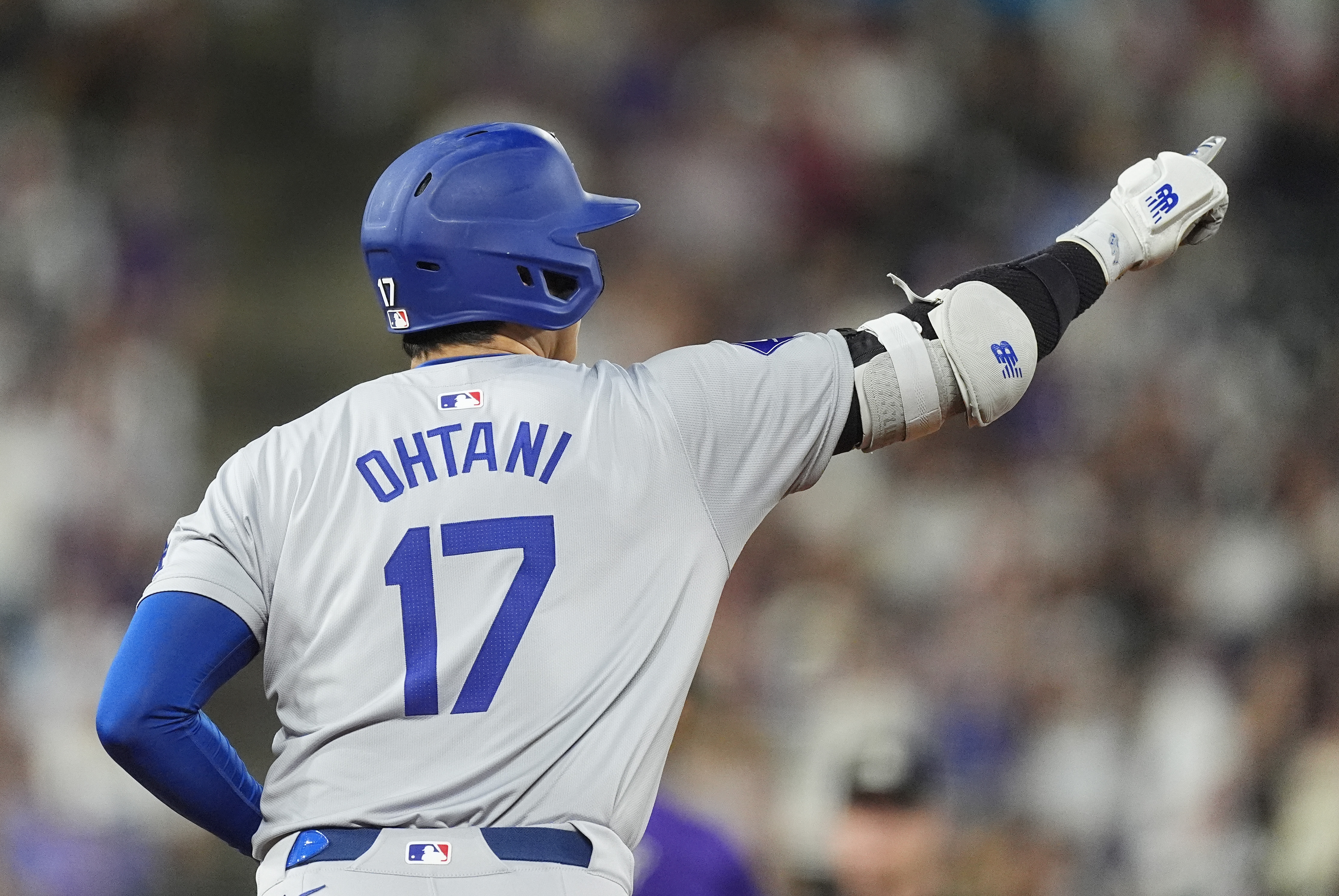 Los Angeles Dodgers' Shohei Ohtani gestures to the bullpen as he circles the bases after hitting a three-run home run off Colorado Rockies relief pitcher Anthony Molina in the sixth inning of a baseball game Friday, Sept. 27, 2024, in Denver.
