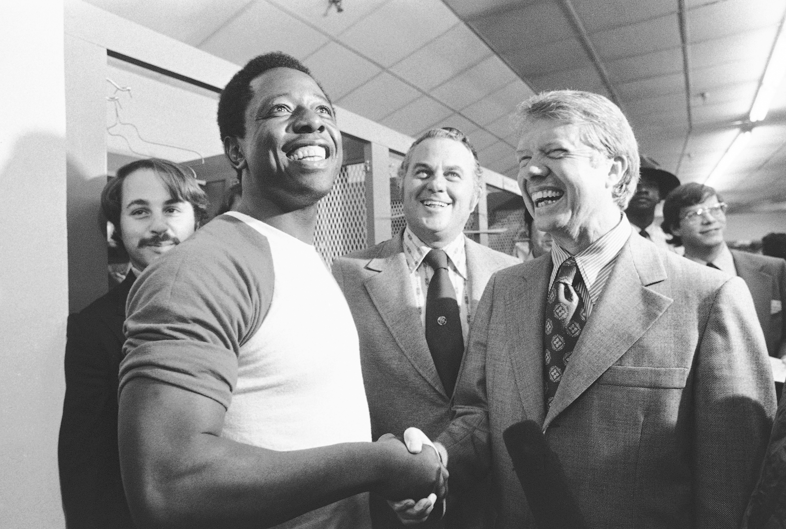 FILE - Georgia Gov. Jimmy Carter, right, and Delaware Gov. Sherman Tribbitt say hello to Atlanta Braves Hank Aaron, left, following a rain canceled game with the Los Angeles Dodgers in Atlanta, Ga., Sept. 27, 1973. 
