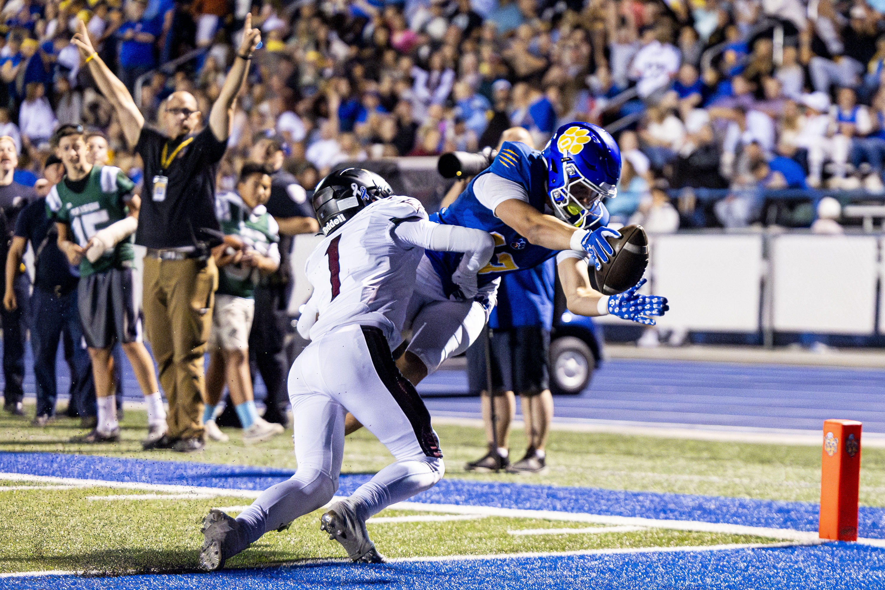 Orem wide receiver Kaue Akana (13) stretches to cross the ball into the end zone for a touchdown while defended by Maple Mountain linebacker Maddox Sabey (1) during a game held at Orem High School in Orem on Friday, Sept. 27, 2024.