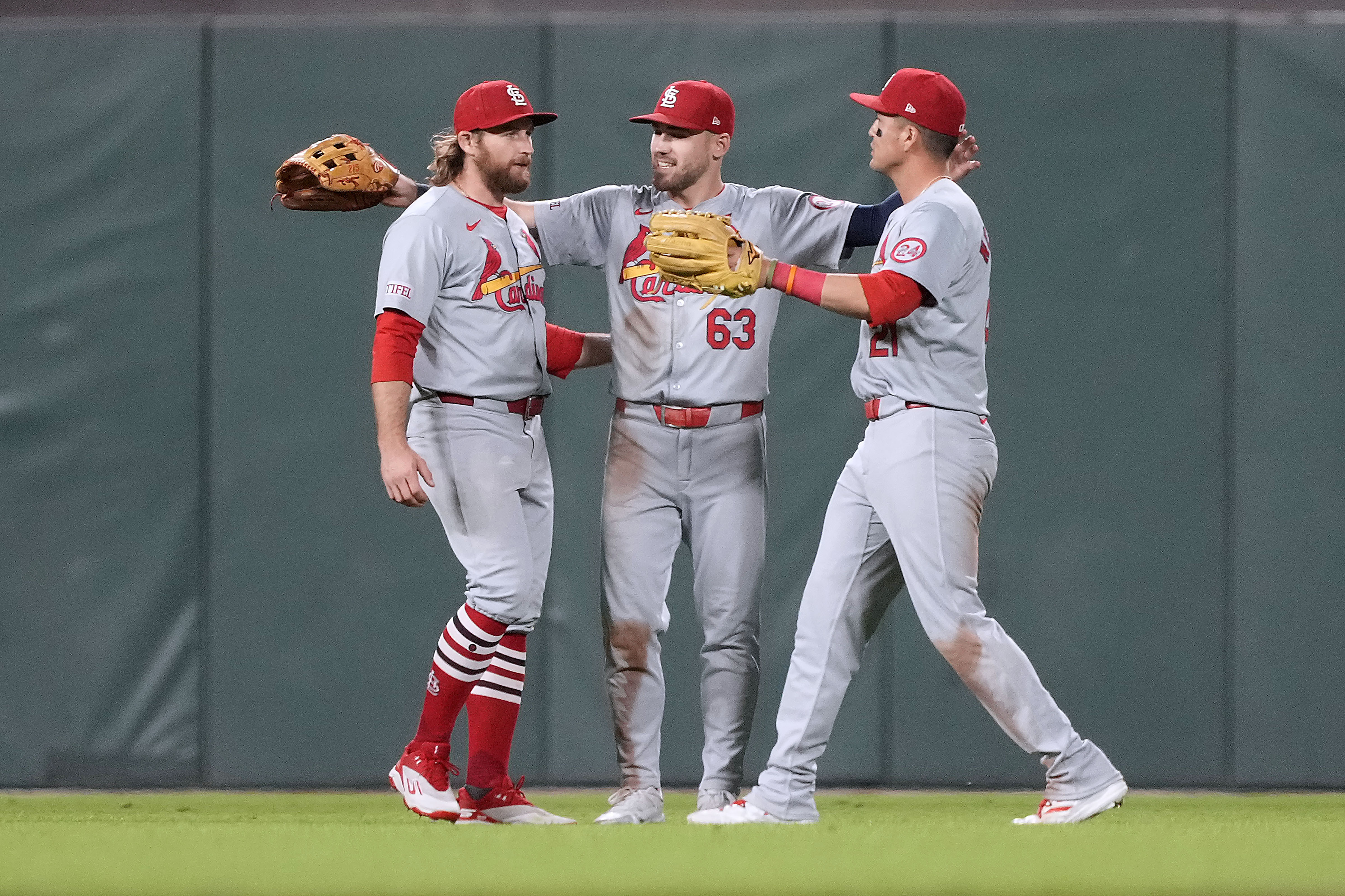 St. Louis Cardinals' Brendan Donovan, left, Michael Siani (63) and Lars Nootbaar celebrate after a victory against the San Francisco Giants in a baseball game Friday, Sept. 27, 2024, in San Francisco. 