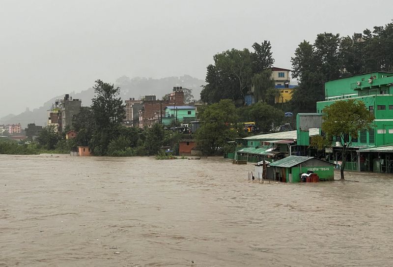 A general view of the overflowing Bagmati River following heavy rains, in Kathmandu, Nepal, on Friday. At least 66 people have been killed in Nepal since early on Friday as persistent downpours triggered flooding and landslides.