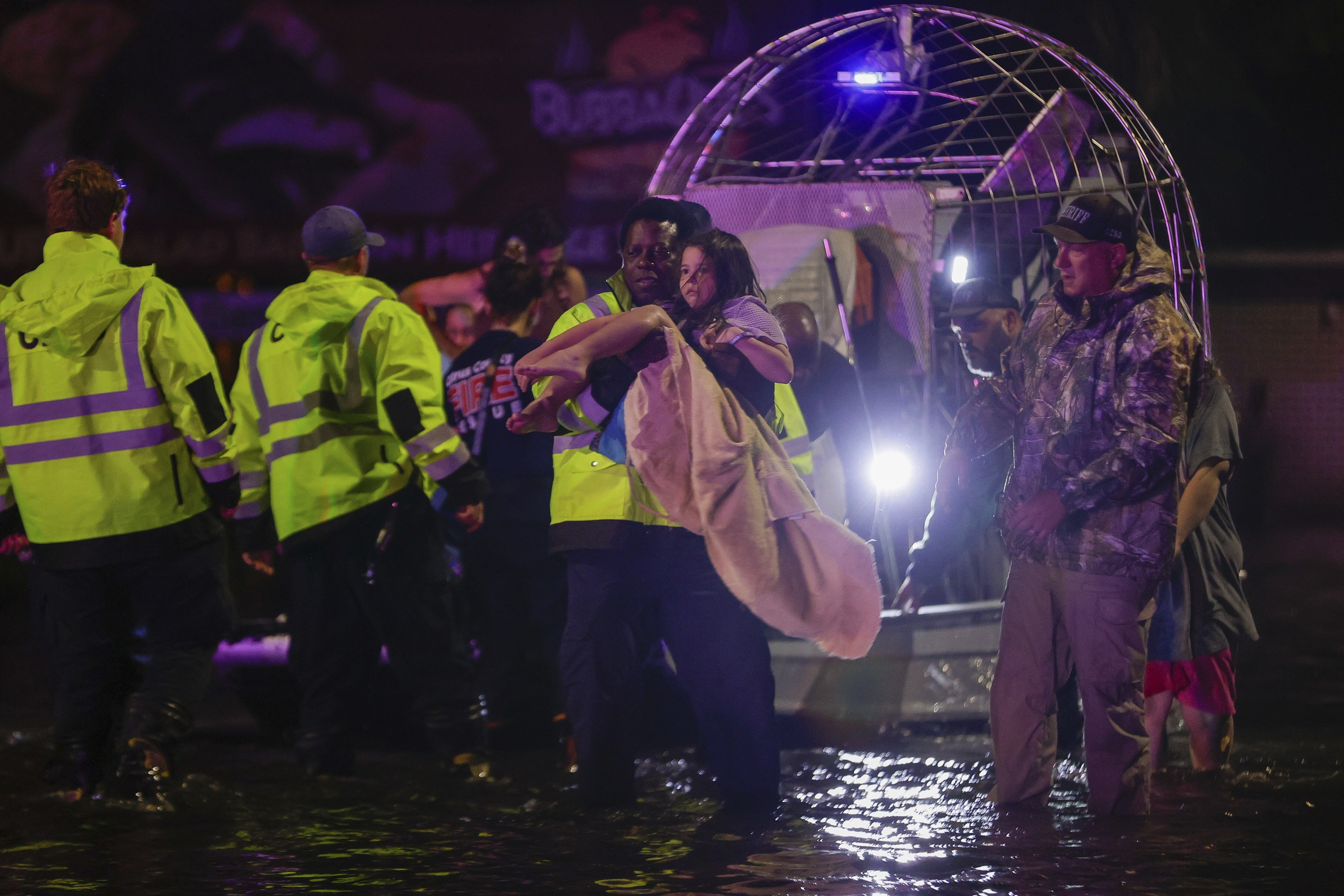 An airboat transports residents rescued from floodwaters in the aftermath of Hurricane Helene on Friday in Crystal River, Fla.